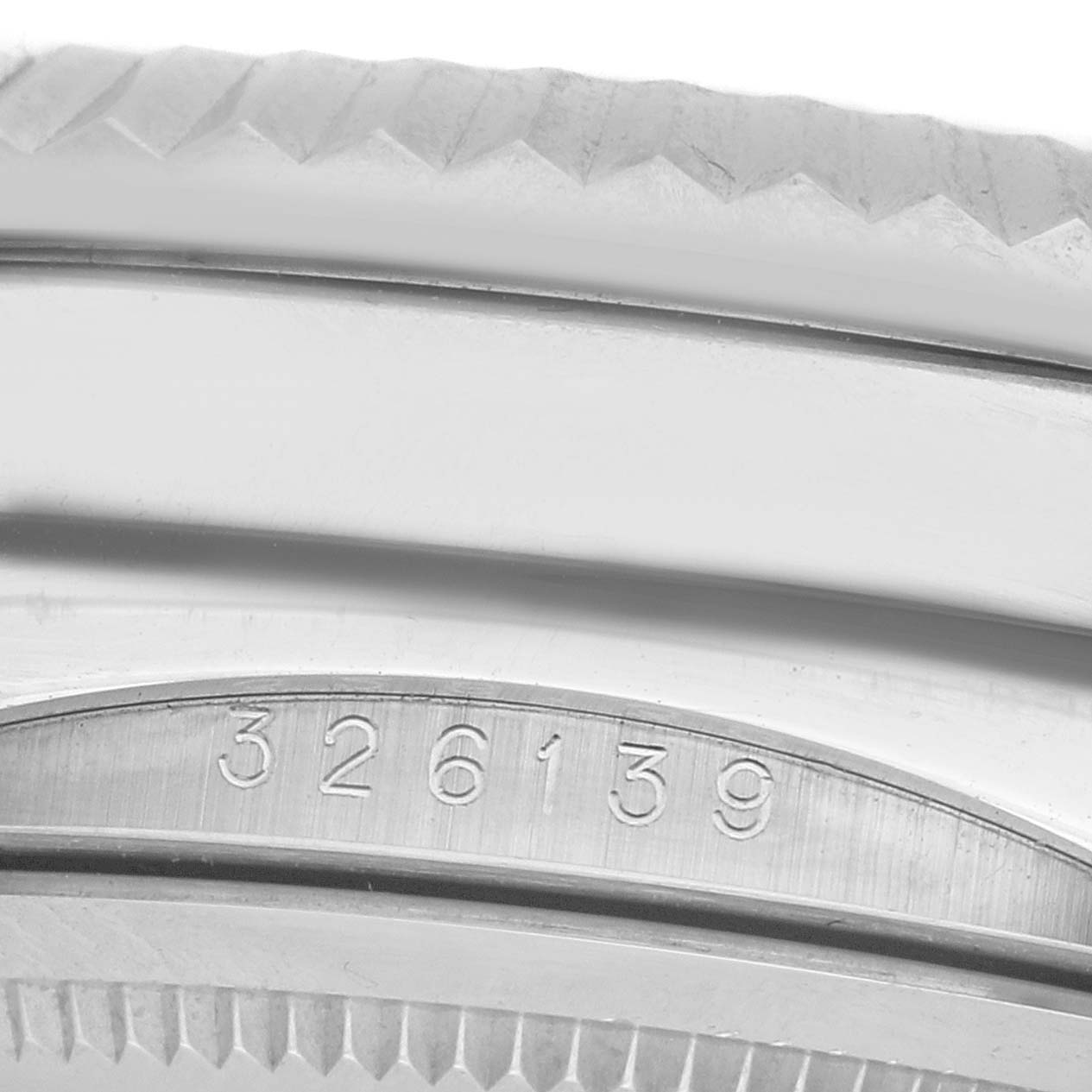 The image shows a close-up of the Rolex Sky-Dweller 326139 Men's White Gold Black Dial's bezel edge and model number engraving.