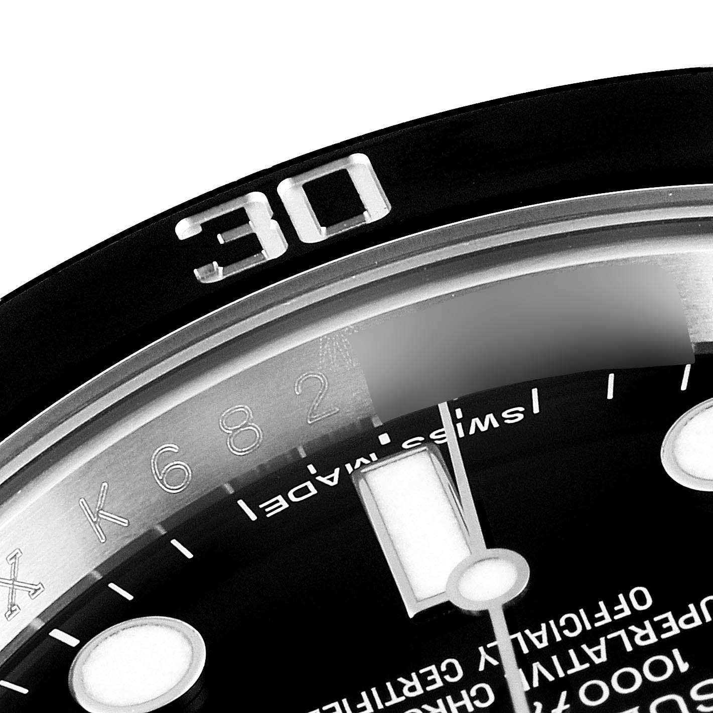 This image shows the 30-minute mark on the bezel and a portion of the dial and hands of a Rolex Submariner 114060 Men's Stainless Steel Black Dial 114060 Men's Stainless Steel Black Dial watch.