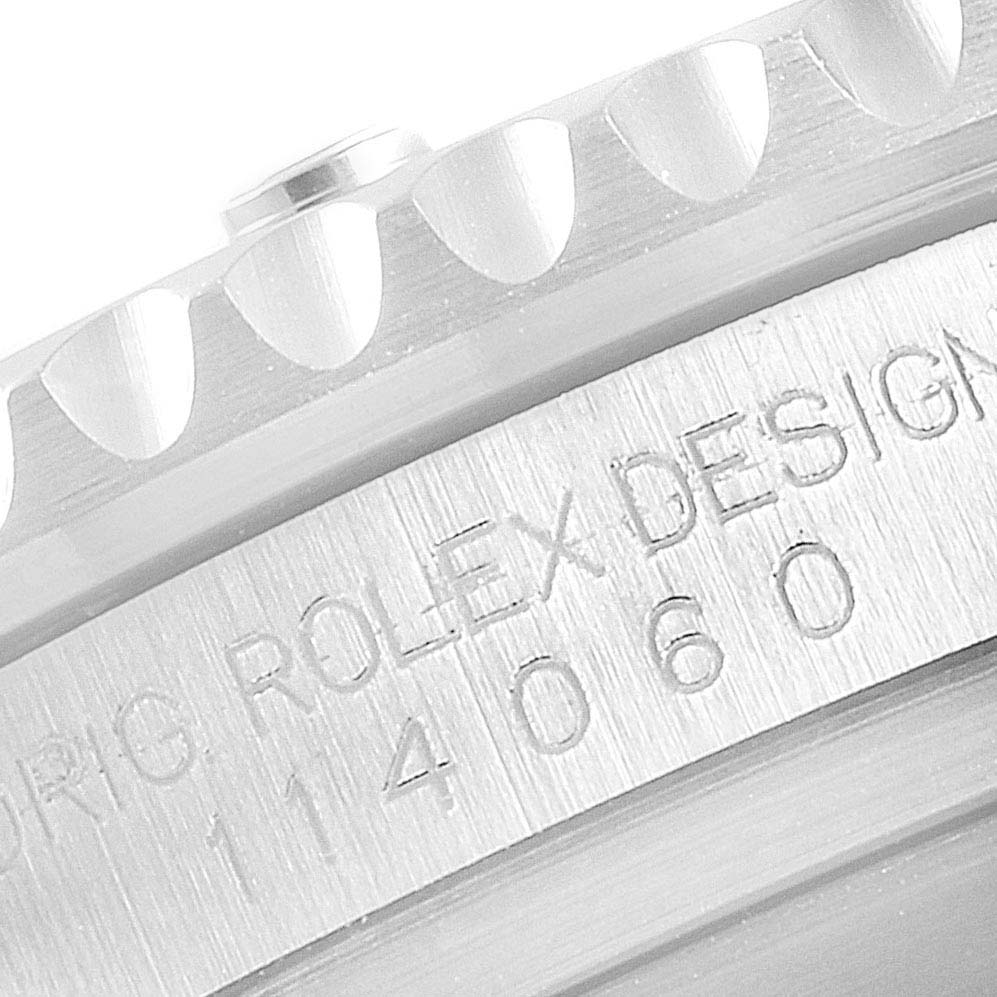 The image shows a close-up of the serial number engraving on the side of the case of a Rolex Submariner 114060 Men's Stainless Steel Black Dial 114060 Men's Stainless Steel Black Dial watch.