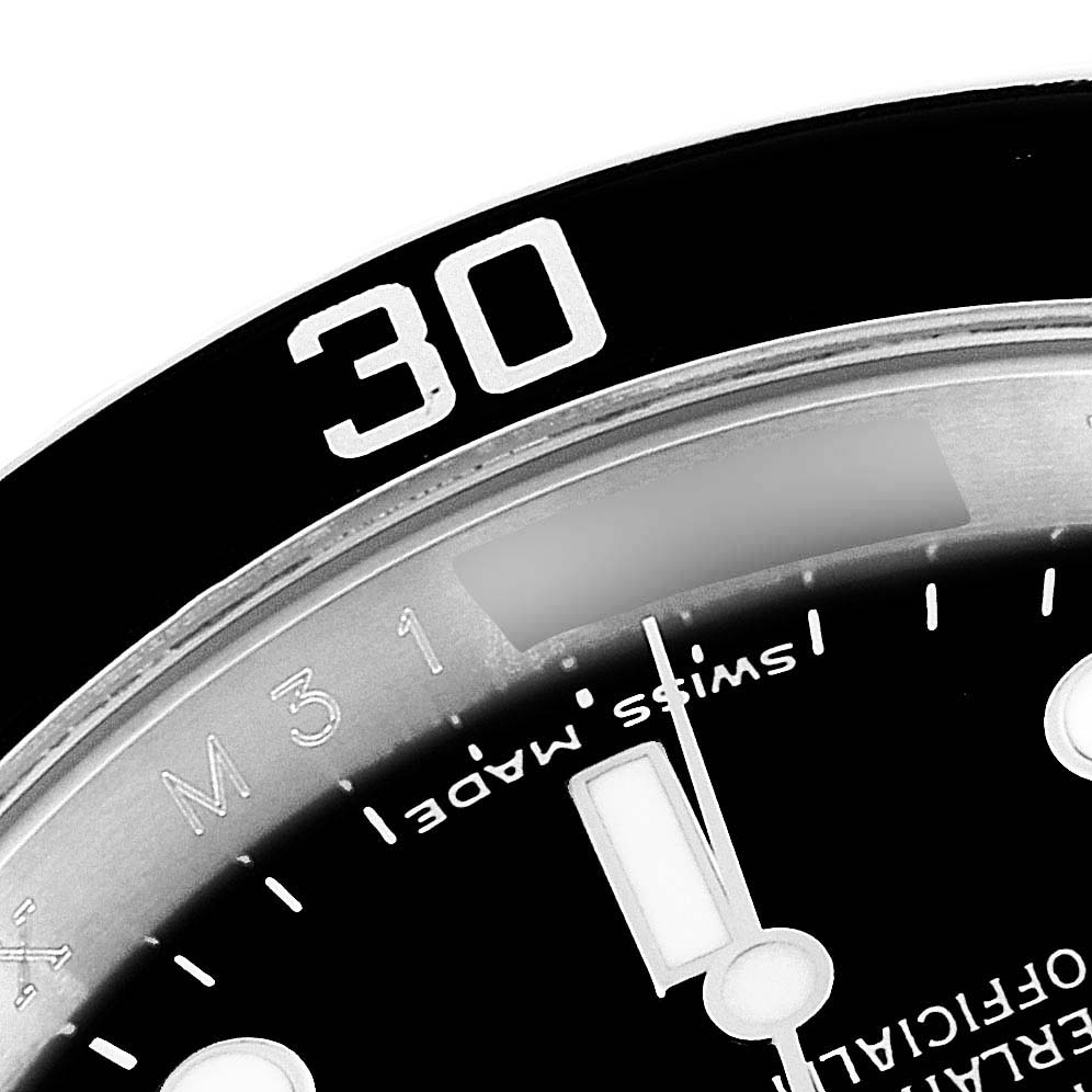 The image shows a close-up of the 30-minute mark on the bezel and part of the dial and hands of a Rolex Submariner 16610 Men
s Stainless Steel Black Dial 16610 Men
s Stainless Steel Black Dial watch.