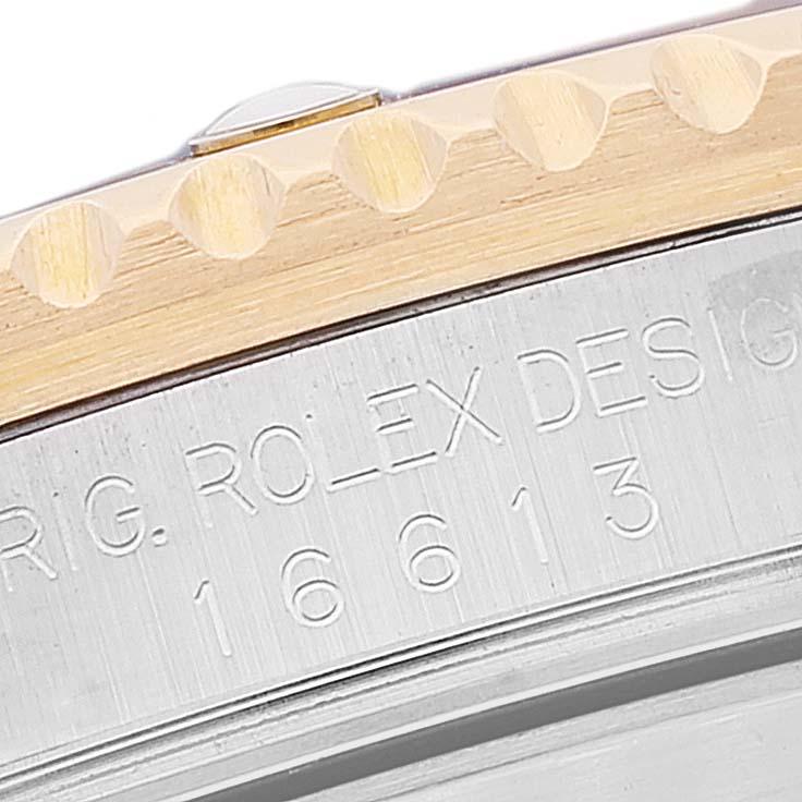 This close-up image shows the engraved side and bezel edge of a Rolex Submariner 16613 Men's Steel and Gold (two tone) Blue Dial 16613 Men's Steel and Gold (two tone) Blue Dial watch model 16613.