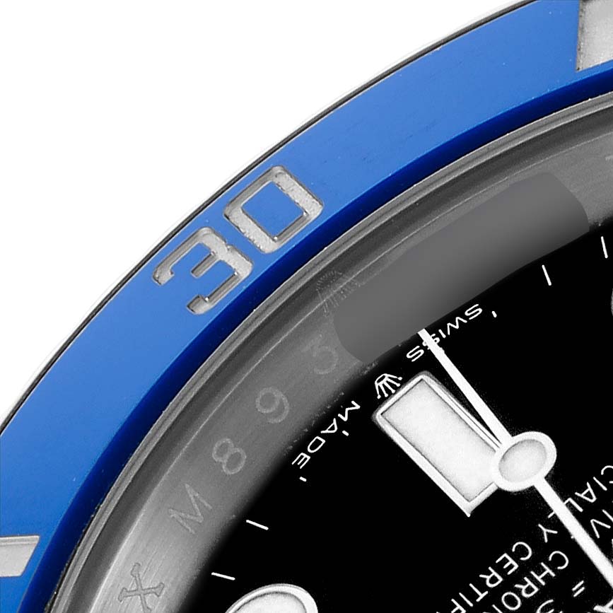 The image shows a close-up of the Rolex Submariner 126619 Men's White Gold Black Dial's blue bezel with the "30" mark and part of the dial, including the hands.