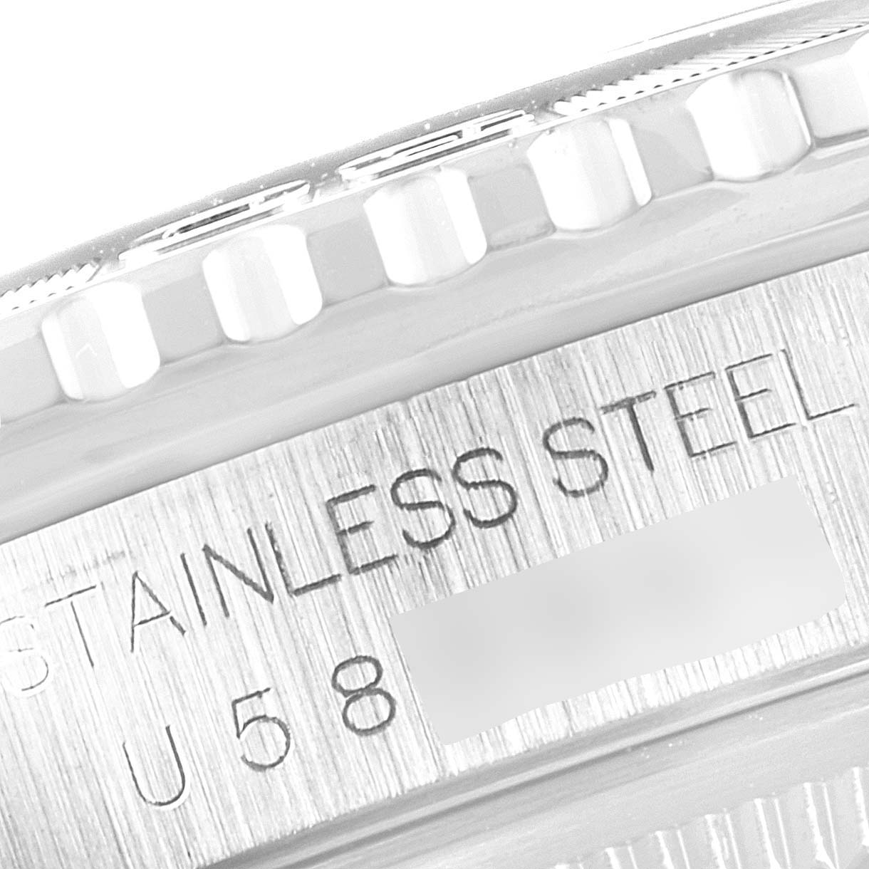 The image shows a close-up of the side of a Rolex Turn-o-Graph 16264 Men
s Stainless Steel Blue Dial 16264 Men
s Stainless Steel Blue Dial watch case with "STAINLESS STEEL" and part of the serial number engraved.