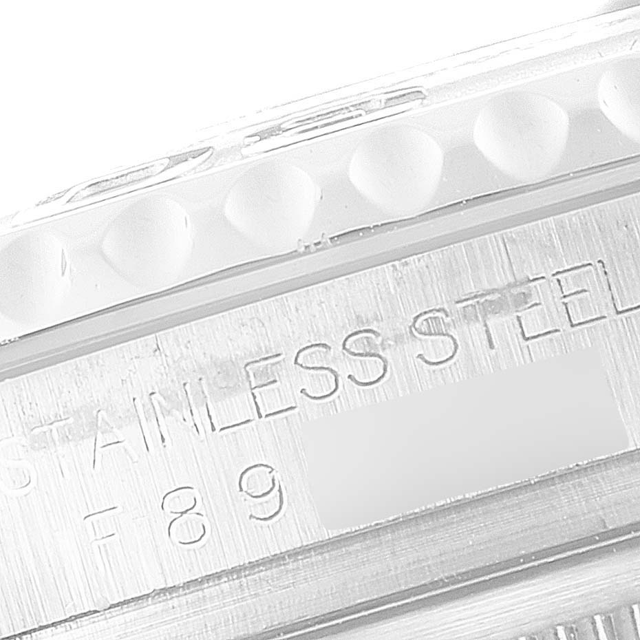 The image shows a close-up angle of the side of a Rolex Yacht-Master 16622 Men
s Stainless Steel Silver Dial 16622 Men
s Stainless Steel Silver Dial watch, focusing on the serial number engraving and part of the bezel.