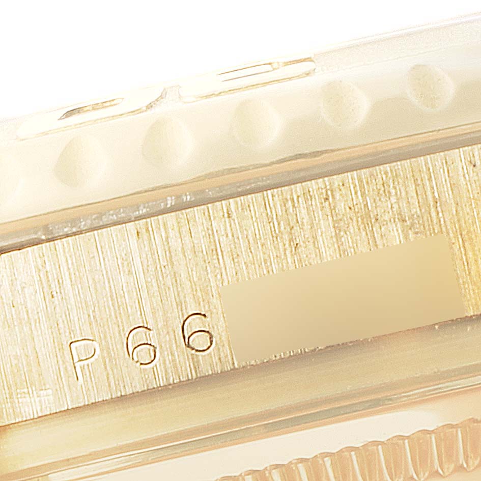 The image shows a close-up of the side of the bezel and case of a Rolex Yacht-Master 16628 Men's Yellow Gold White Dial 16628 Men's Yellow Gold White Dial watch, including part of its serial number.