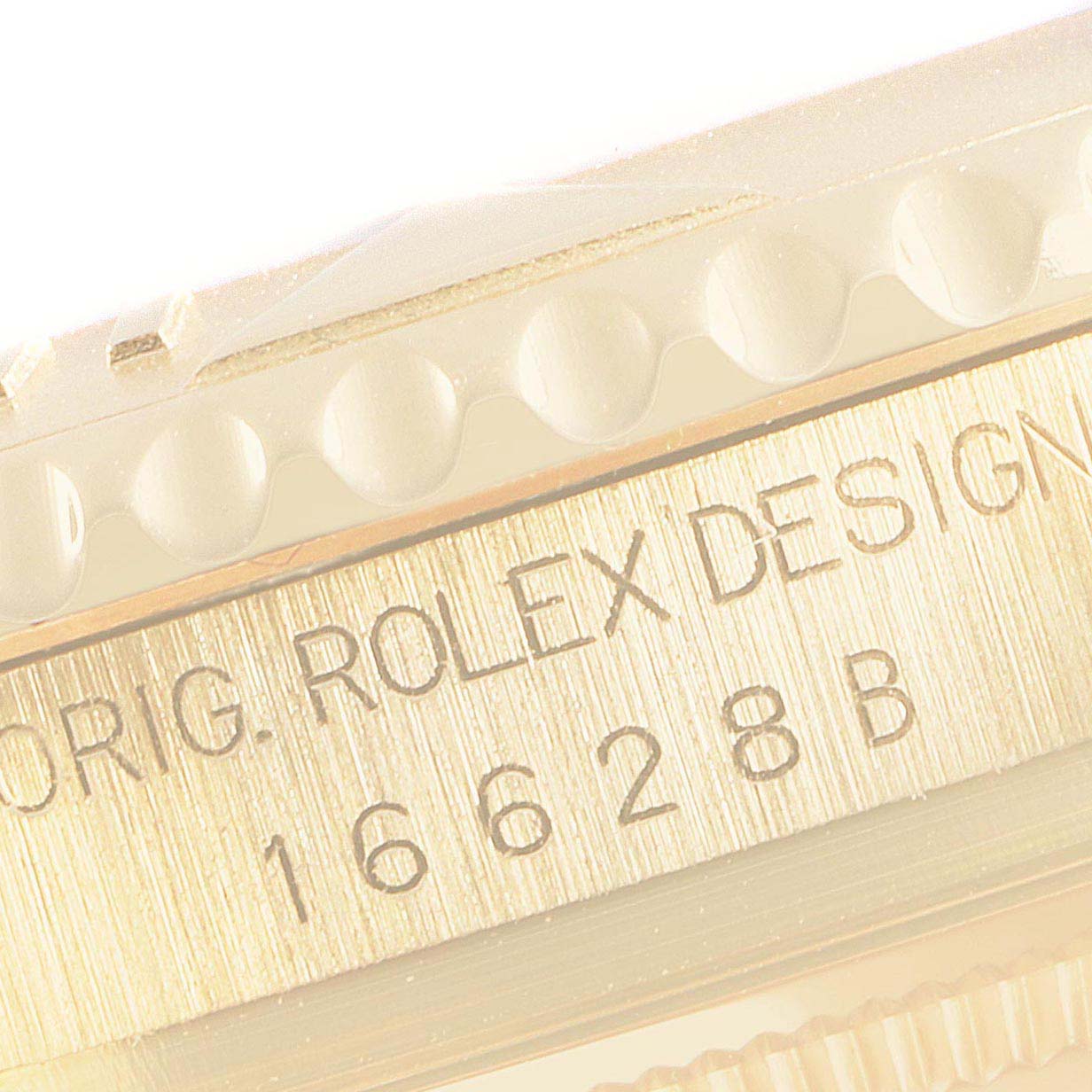This image shows a close-up of the serial and model number engraving on the Rolex Yacht-Master 16628 Men's Yellow Gold White Dial 16628 Men's Yellow Gold White Dial bezel and case.