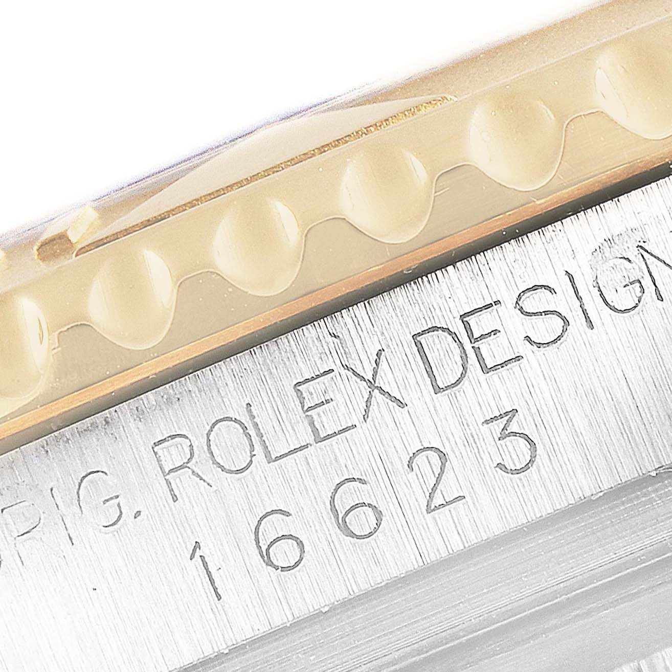 Close-up showing the bezel and engraved serial number on a Rolex Yacht-Master 16623 Men's Stainless Steel Champagne Dial 16623 Men's Stainless Steel Champagne Dial watch.