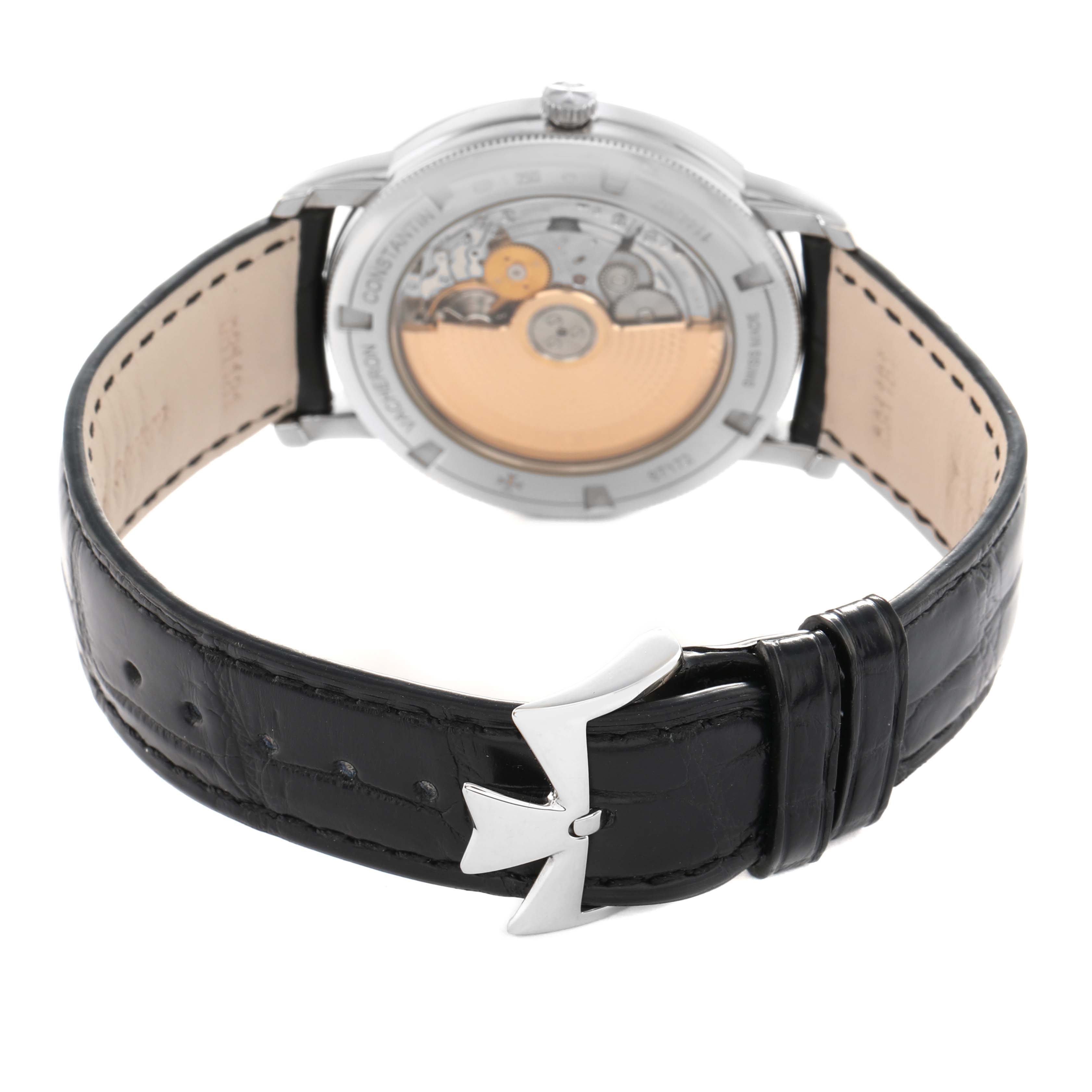 The Vacheron Constantin Traditionnelle 87172 Men's White Gold Silver Dial watch is shown from the back, highlighting the movement and black leather strap with clasp.