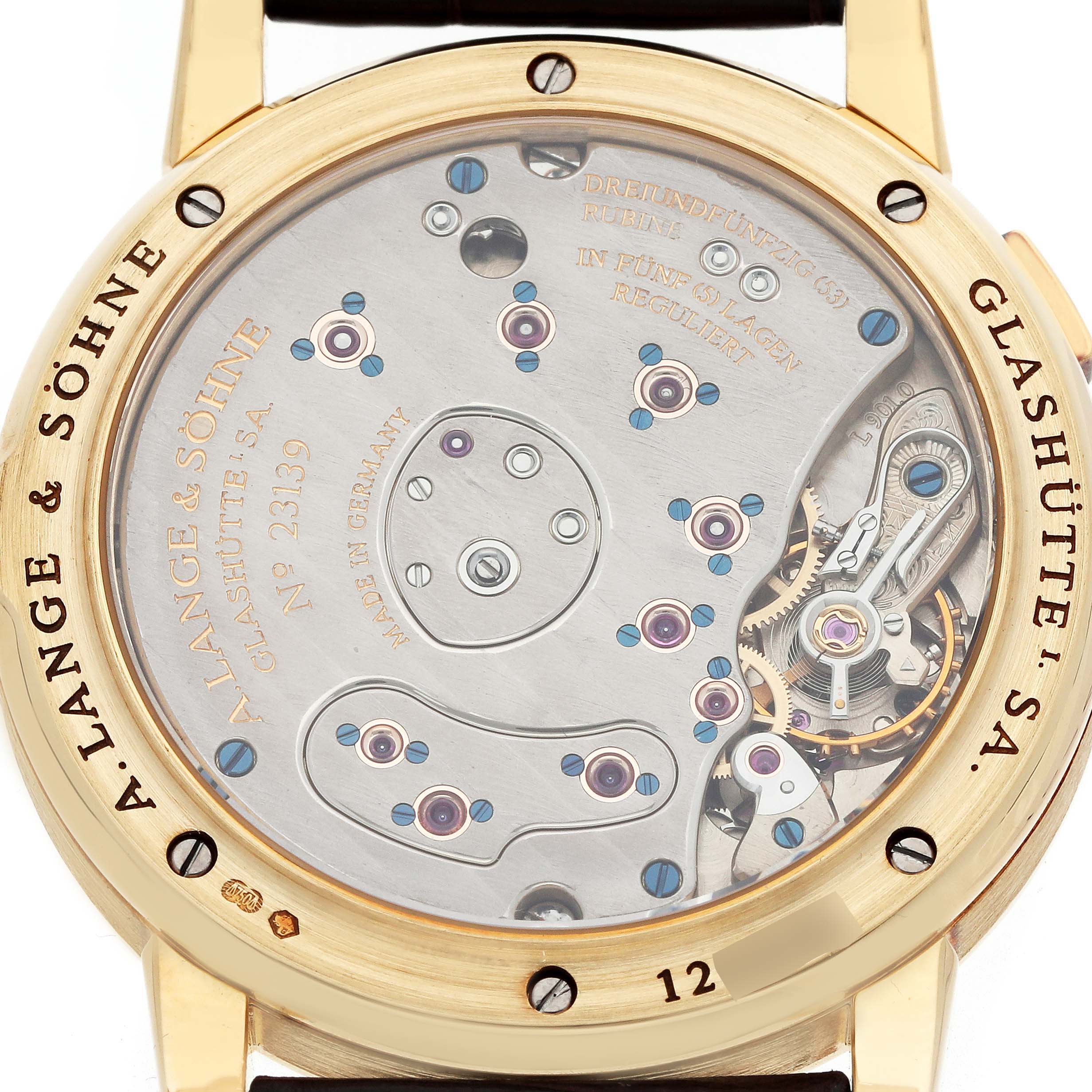 The image shows the back view of an A. Lange & Sohne Lange 1 101.021 Men's Yellow Gold Silver Dial watch, revealing intricate mechanical components.