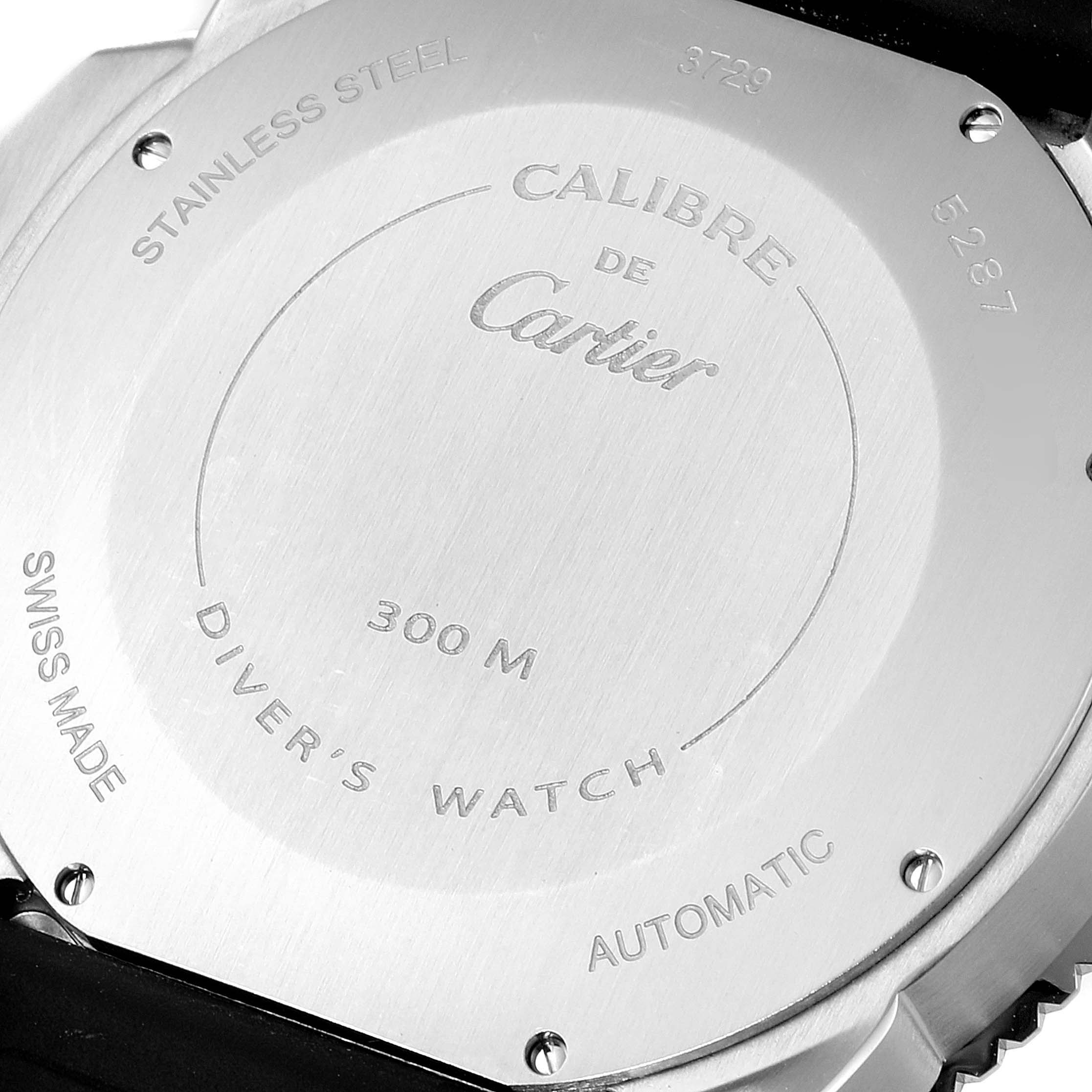 The image shows the back case of the Calibre de Cartier watch by Cartier, highlighting its stainless steel construction and inscriptions.
