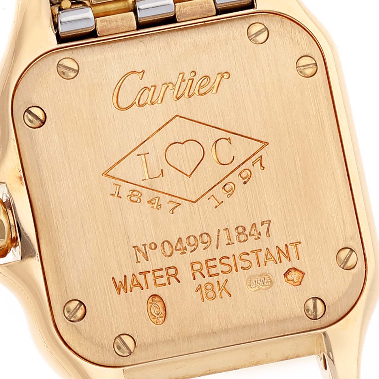 The image shows the backside of a Cartier Panthere W25046S1 Women's Steel and Gold (two tone) Silver Dial W25046S1 Women's Steel and Gold (two tone) Silver Dial model watch, displaying its engravings and bracelet attachments.