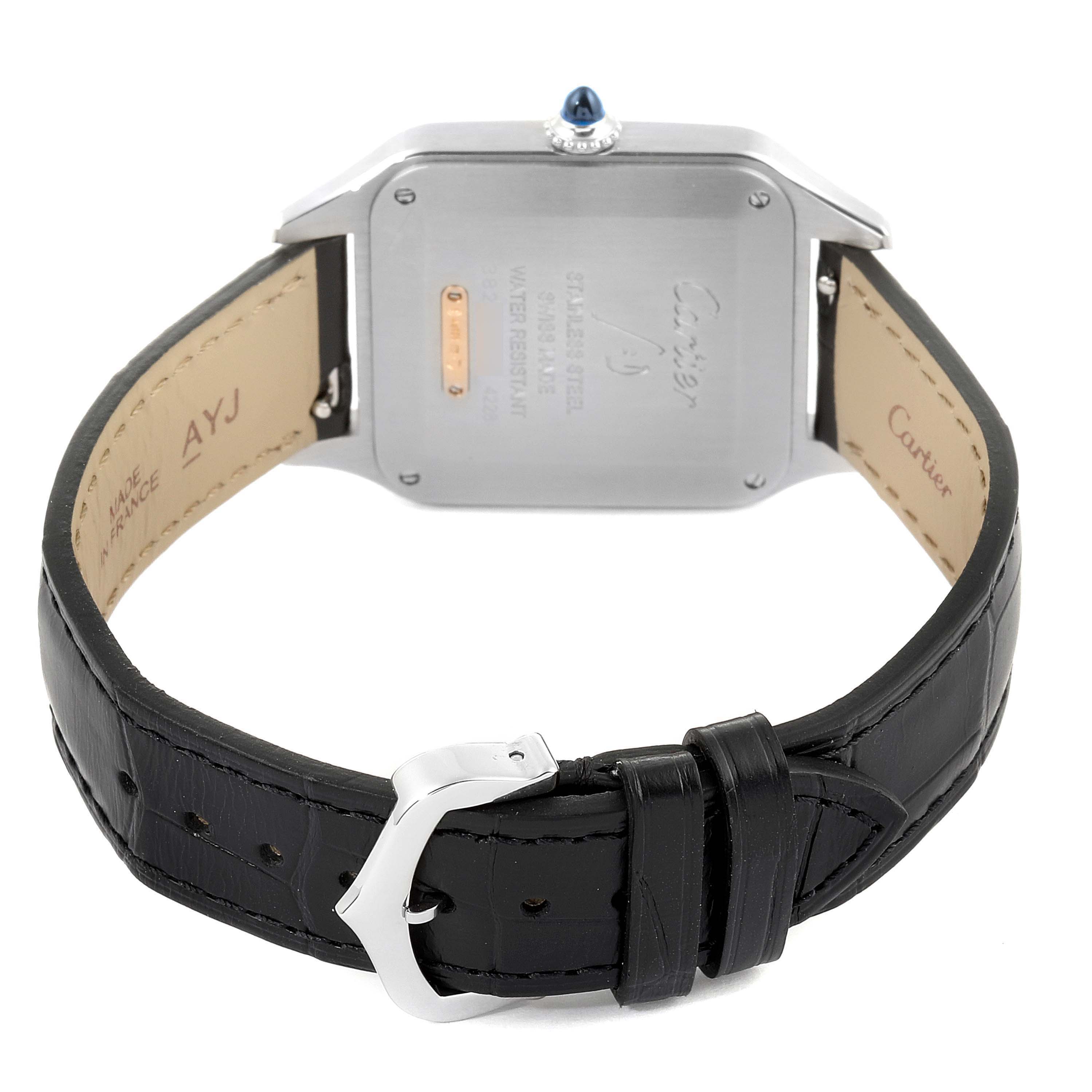 The image shows the back of a Santos Dumont watch by Cartier, including the case back and black leather strap with a silver buckle.
