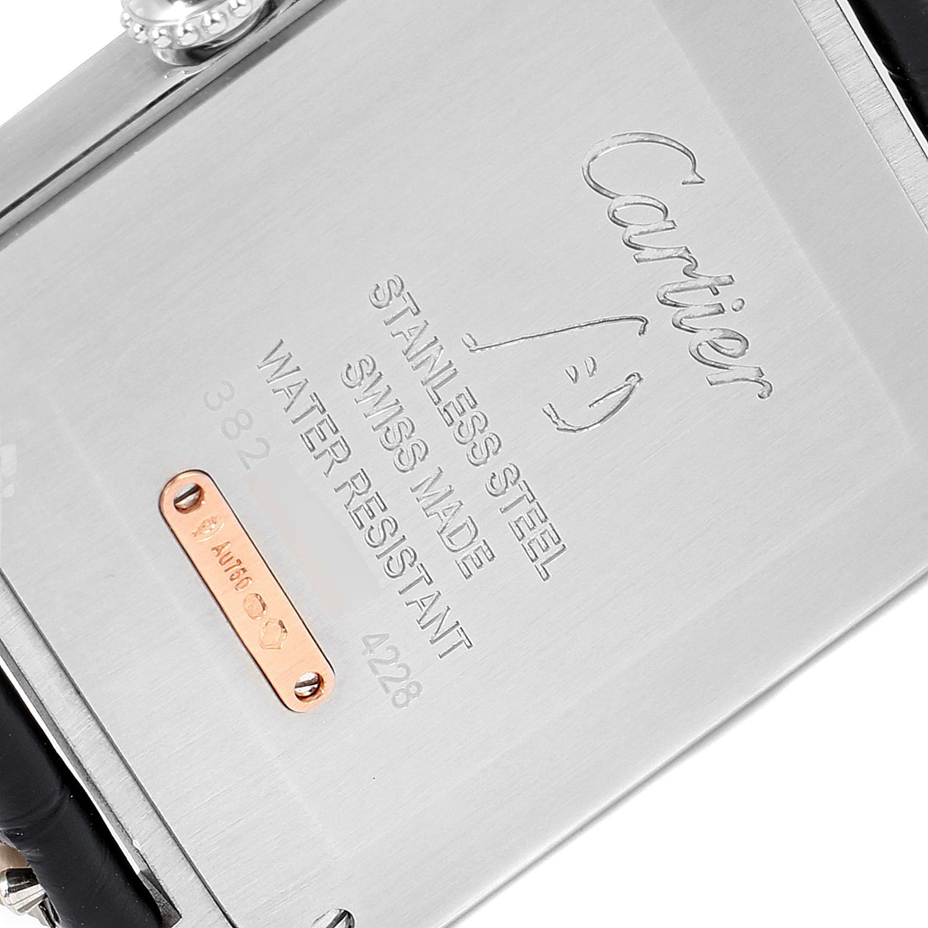 The image shows the back of the Santos Dumont model watch by Cartier, highlighting its inscriptions and metal components.