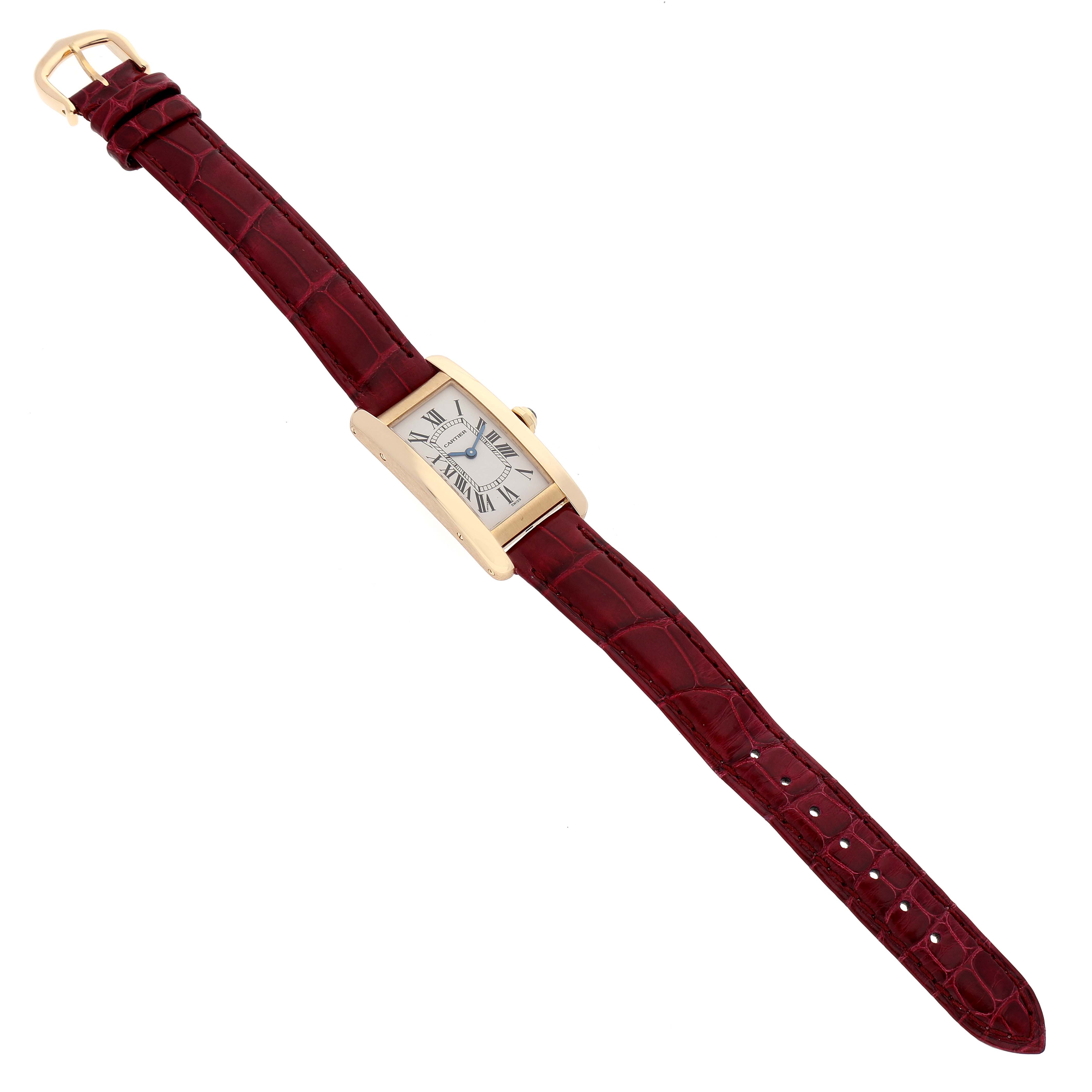 The Cartier Tank Americaine W2601556 Women
s Yellow Gold Silver Dial W2601556 Women
s Yellow Gold Silver Dial watch is shown from a top-down angle, displaying its rectangular case, white dial, and maroon leather strap.