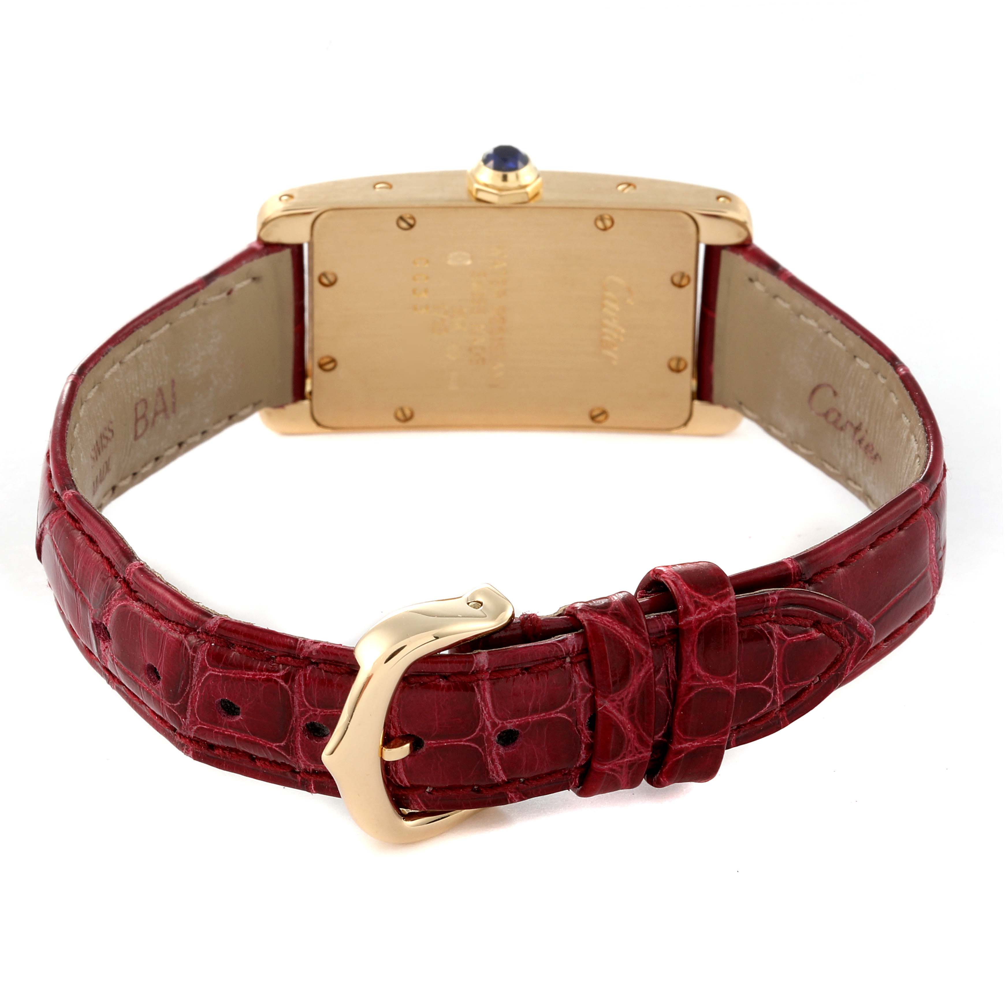 The image shows the back view of the Cartier Tank Americaine W2601556 Women
s Yellow Gold Silver Dial W2601556 Women
s Yellow Gold Silver Dial watch, displaying its gold case and red leather strap with a buckle.