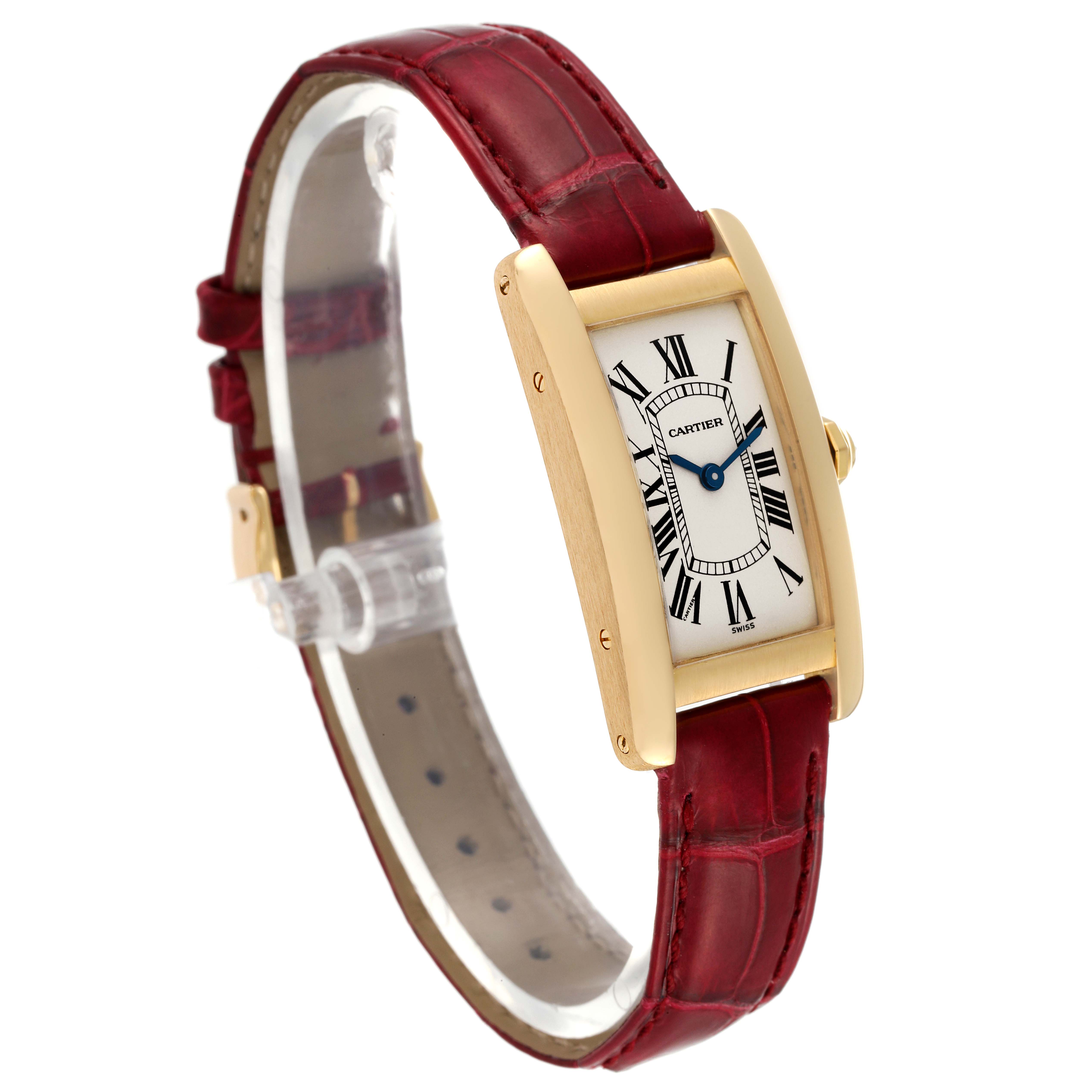 The Cartier Tank Americaine W2601556 Women
s Yellow Gold Silver Dial W2601556 Women
s Yellow Gold Silver Dial watch is angled showing the face, side, case, and red leather strap.