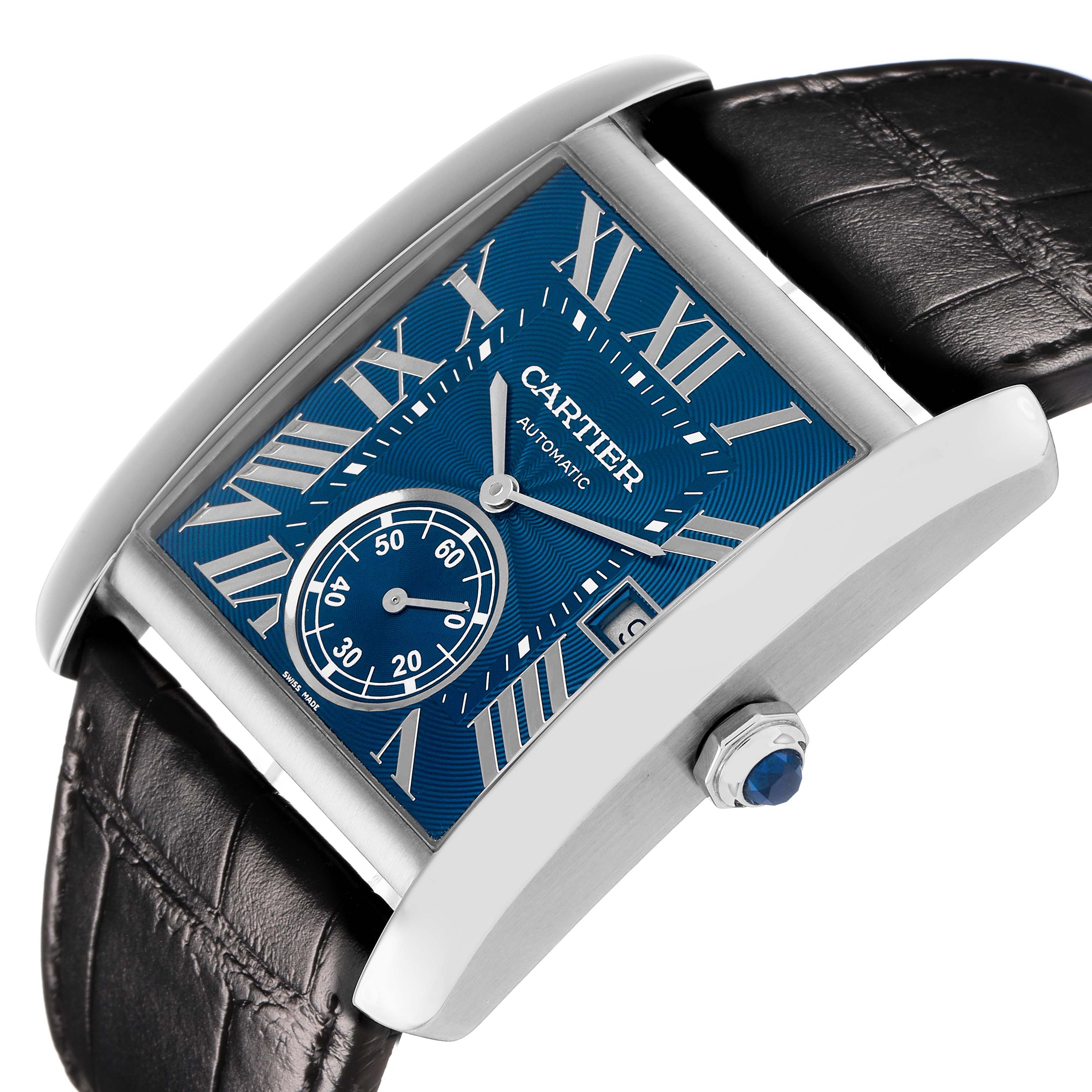 The Cartier Tank MC WSTA0010 Men's Stainless Steel Blue Dial watch is shown at a tilted angle, highlighting the blue dial, Roman numerals, and leather strap.
