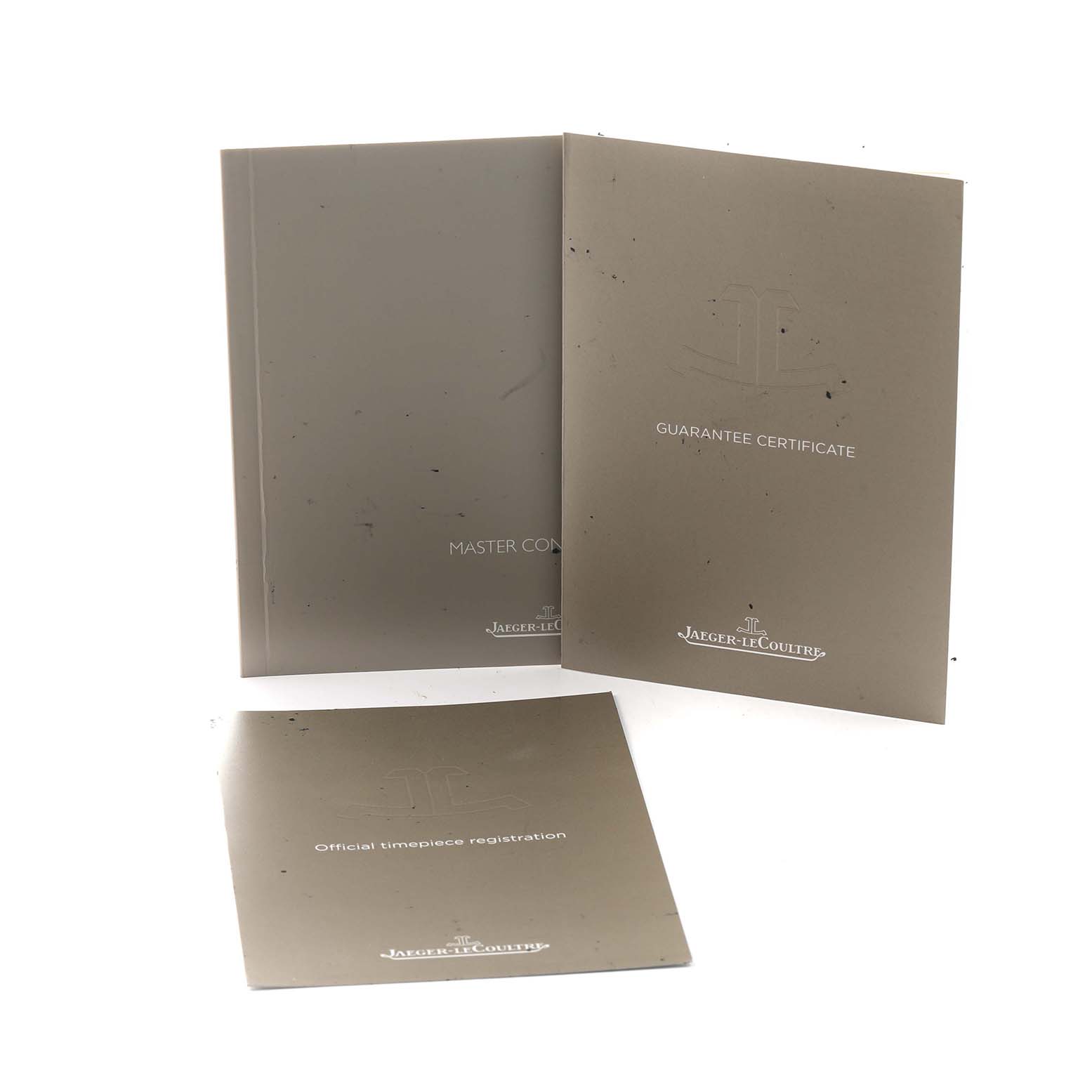 The image shows the manuals and certificates for the Jaeger-LeCoultre Master model, including a guarantee certificate and registration booklet.