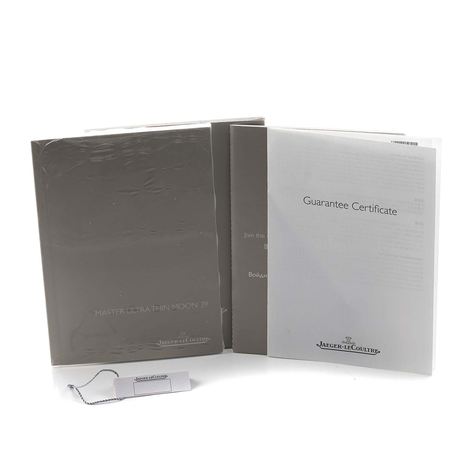 The image shows the documents and tag for a Jaeger-LeCoultre Master model, including a manual and a guarantee certificate.