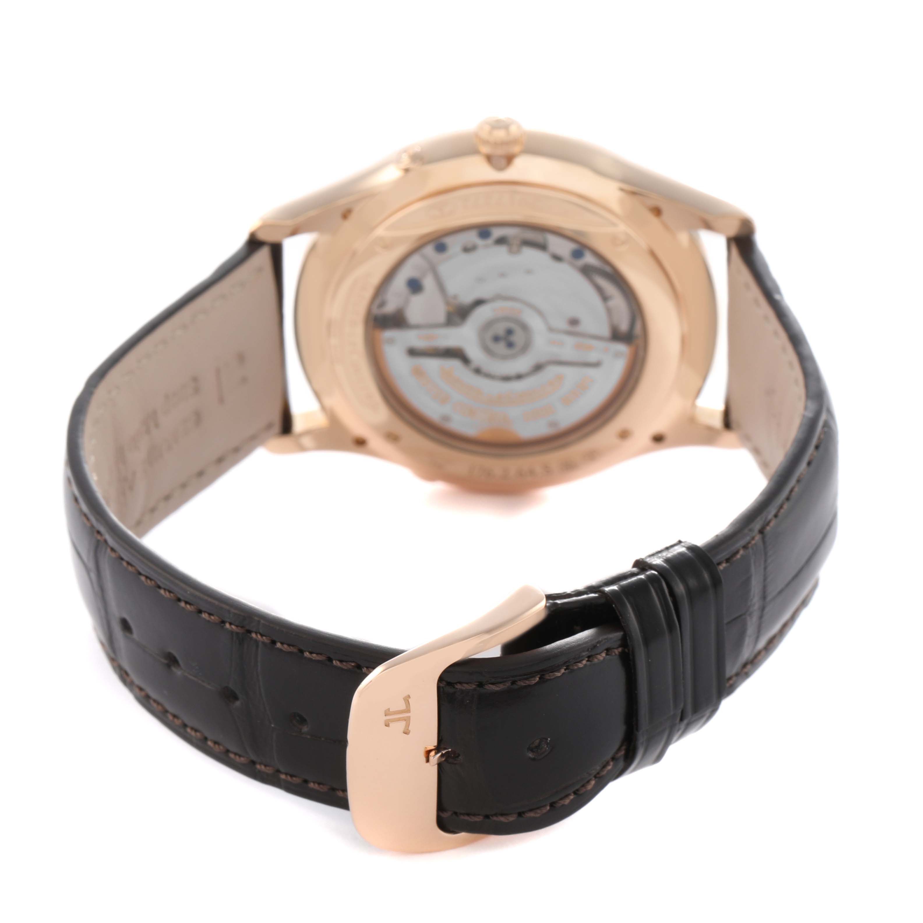 The watch is shown from the back, highlighting the movement of the Jaeger LeCoultre Master Q136256C Men's Rose Gold Brown Dial model and its leather strap.