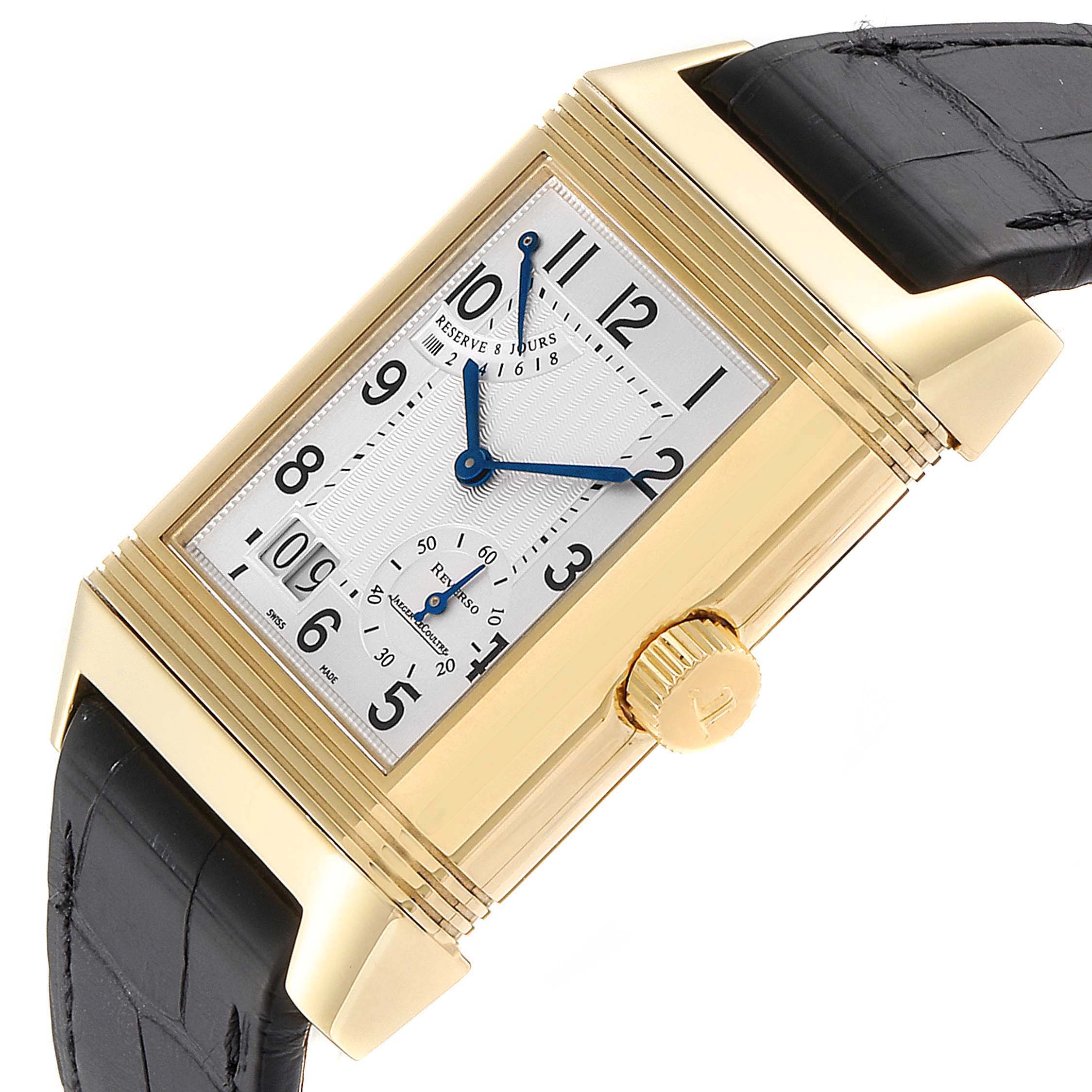 The image shows a close-up, angled view of the Jaeger LeCoultre Reverso Q3001420 Men's Yellow Gold Silver Dial Q3001420 Men's Yellow Gold Silver Dial watch, highlighting its dial, crown, and part of the strap.