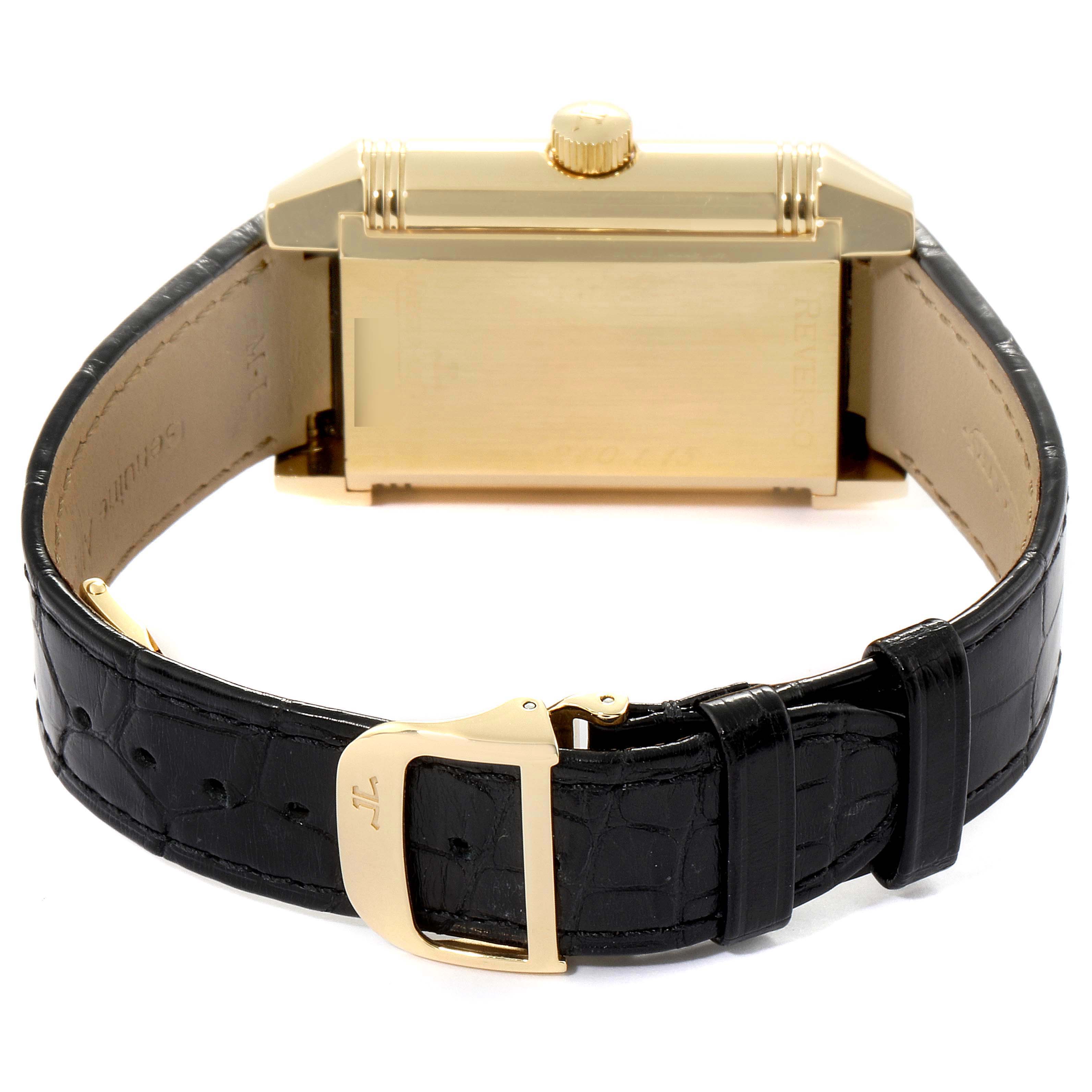The image shows the underside and clasp of a Reverso model by Jaeger LeCoultre with a black leather strap.