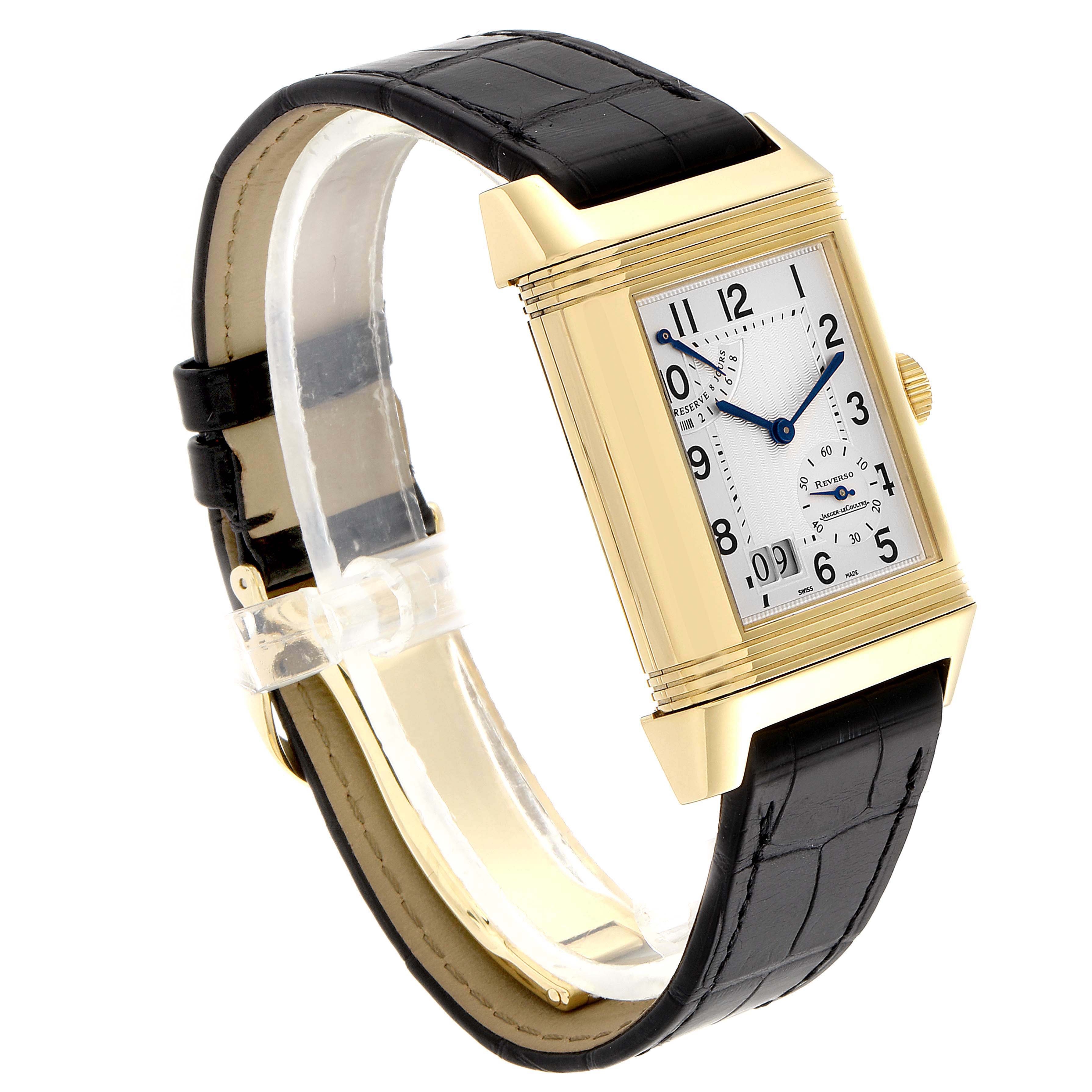 This image shows a Jaeger LeCoultre Reverso Q3001420 Men's Yellow Gold Silver Dial Q3001420 Men's Yellow Gold Silver Dial watch at an angled view, highlighting its rectangular face and black leather strap.