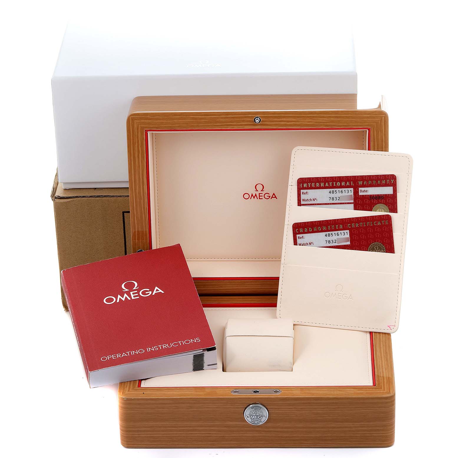 The image shows the packaging of an Omega De Ville 4851.61.31 Men's Stainless Steel Red Dial 4851.61.31 Men's Stainless Steel Red Dial watch, including the box, operating instructions, and warranty cards.