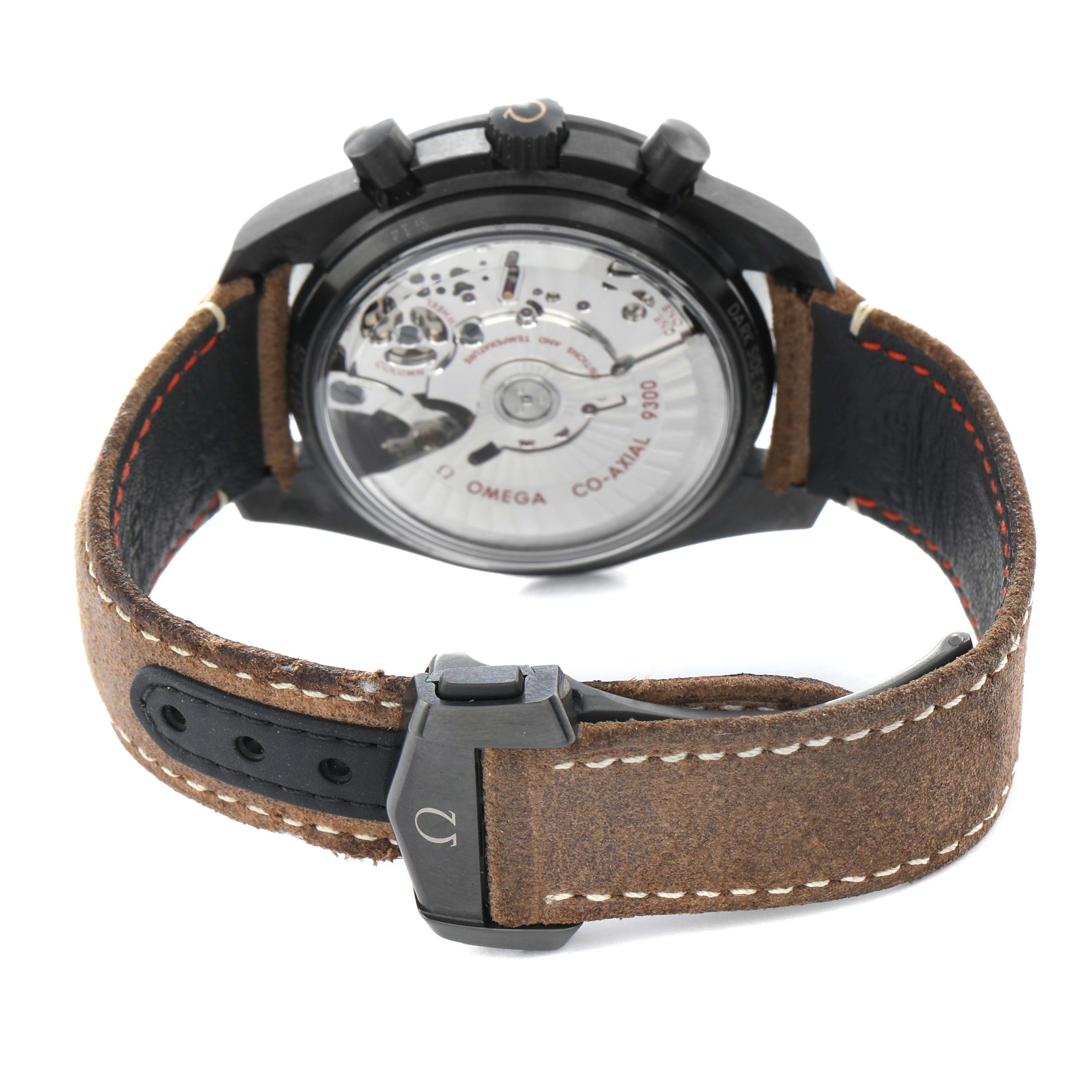 The Omega Speedmaster 311.92.44.51.01.006 Men's Ceramic Black Dial watch is shown from the rear, highlighting the transparent case back and leather strap.