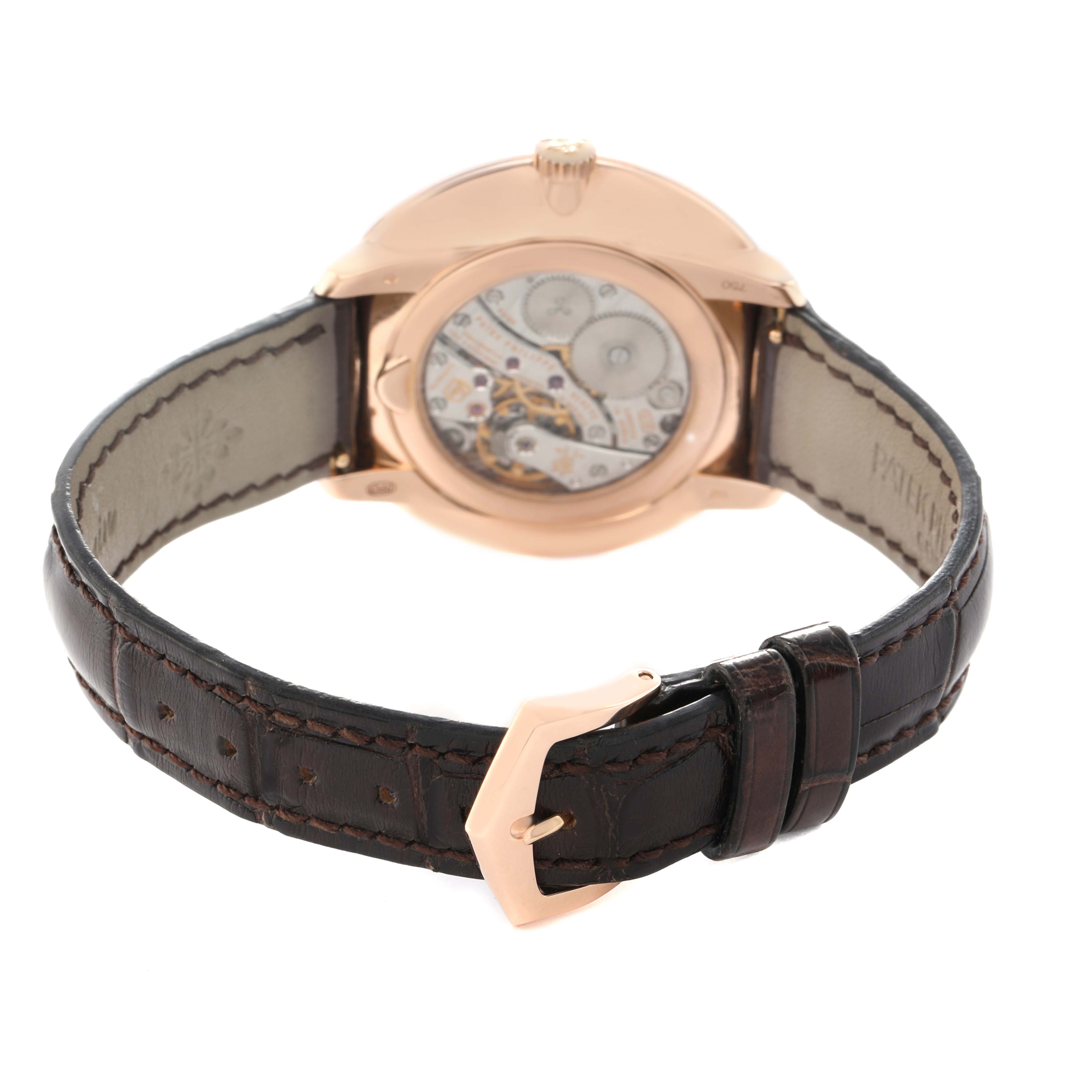 The image shows the back of the Patek Philippe Calatrava 5123R Men's Rose Gold Silver Dial watch, highlighting the movement and brown leather strap with a gold buckle.
