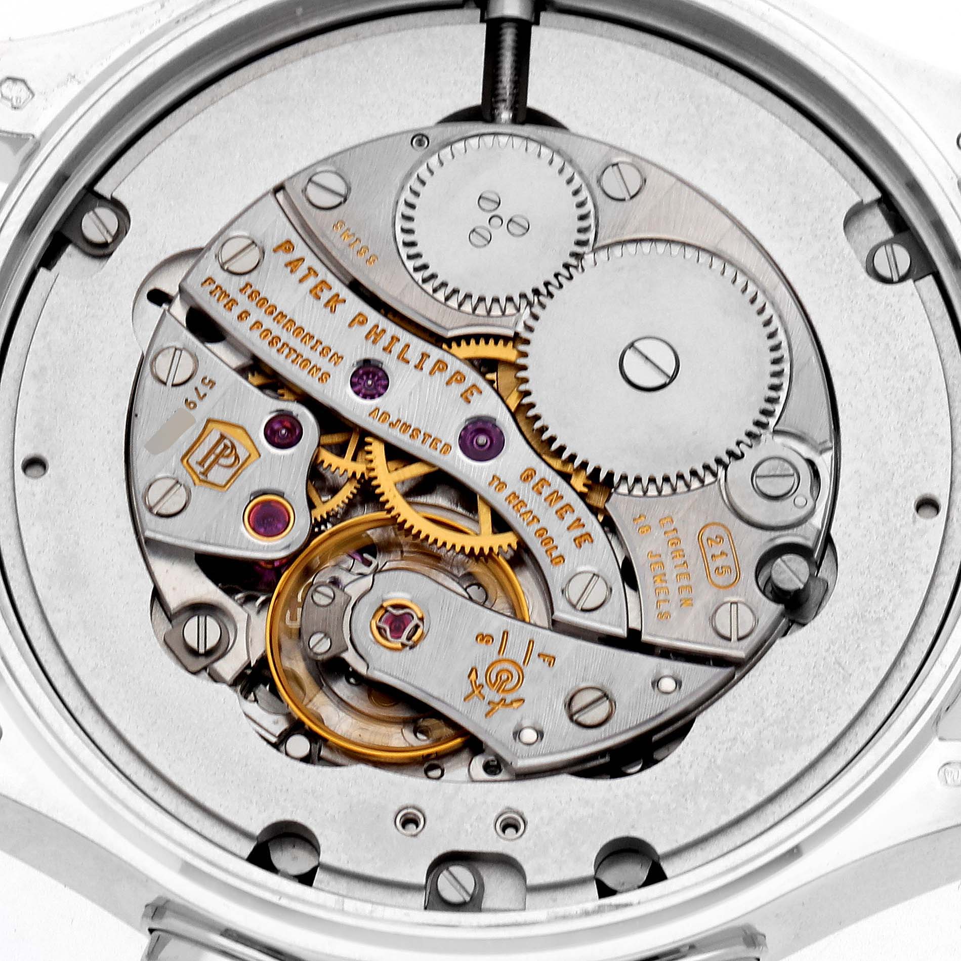 The image shows a close-up view of the Calatrava's movement mechanism by Patek Philippe, highlighting gears and components.