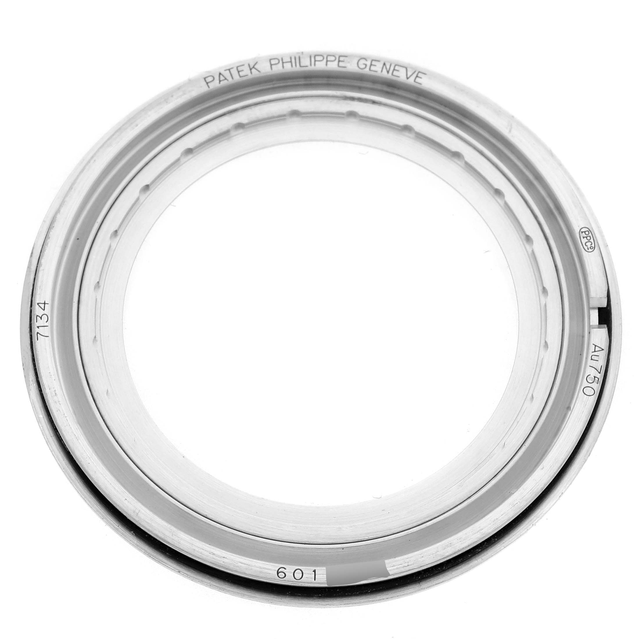 The image shows a top-down view of the Patek Philippe Calatrava 7134G Men's White Gold Brown Dial watch bezel, featuring markings like "AU 750" and "7134."