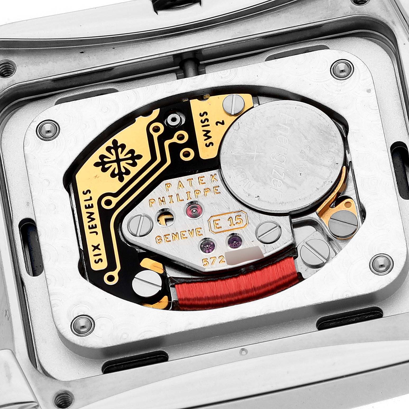 The image shows the movement and battery compartment of a Patek Philippe Twenty-4 4910/10A Women's Stainless Steel Blue Dial watch from a close-up angle.