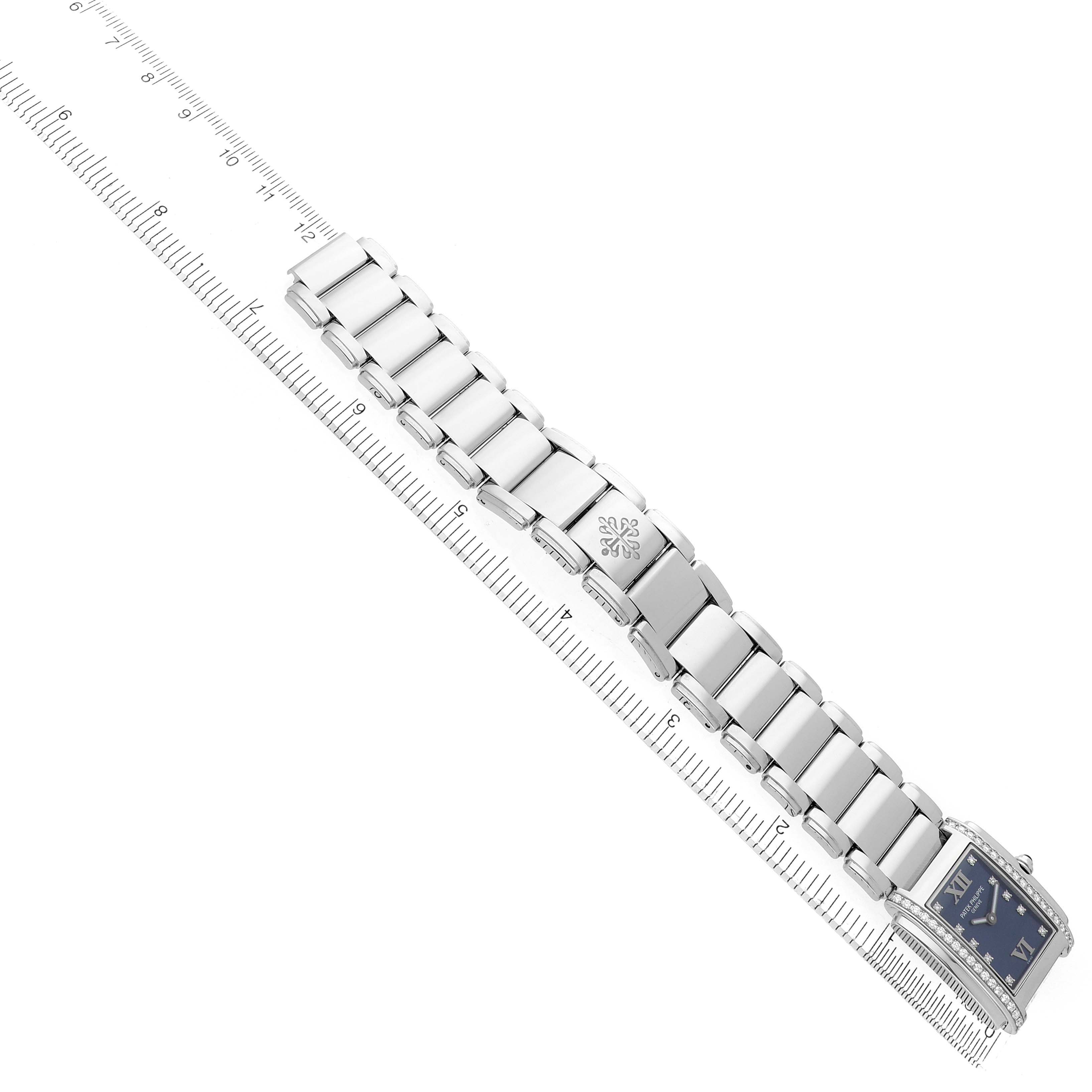The image shows a Patek Philippe Twenty-4 4910/10A Women's Stainless Steel Blue Dial watch at a diagonal angle, highlighting its bracelet and rectangular face.