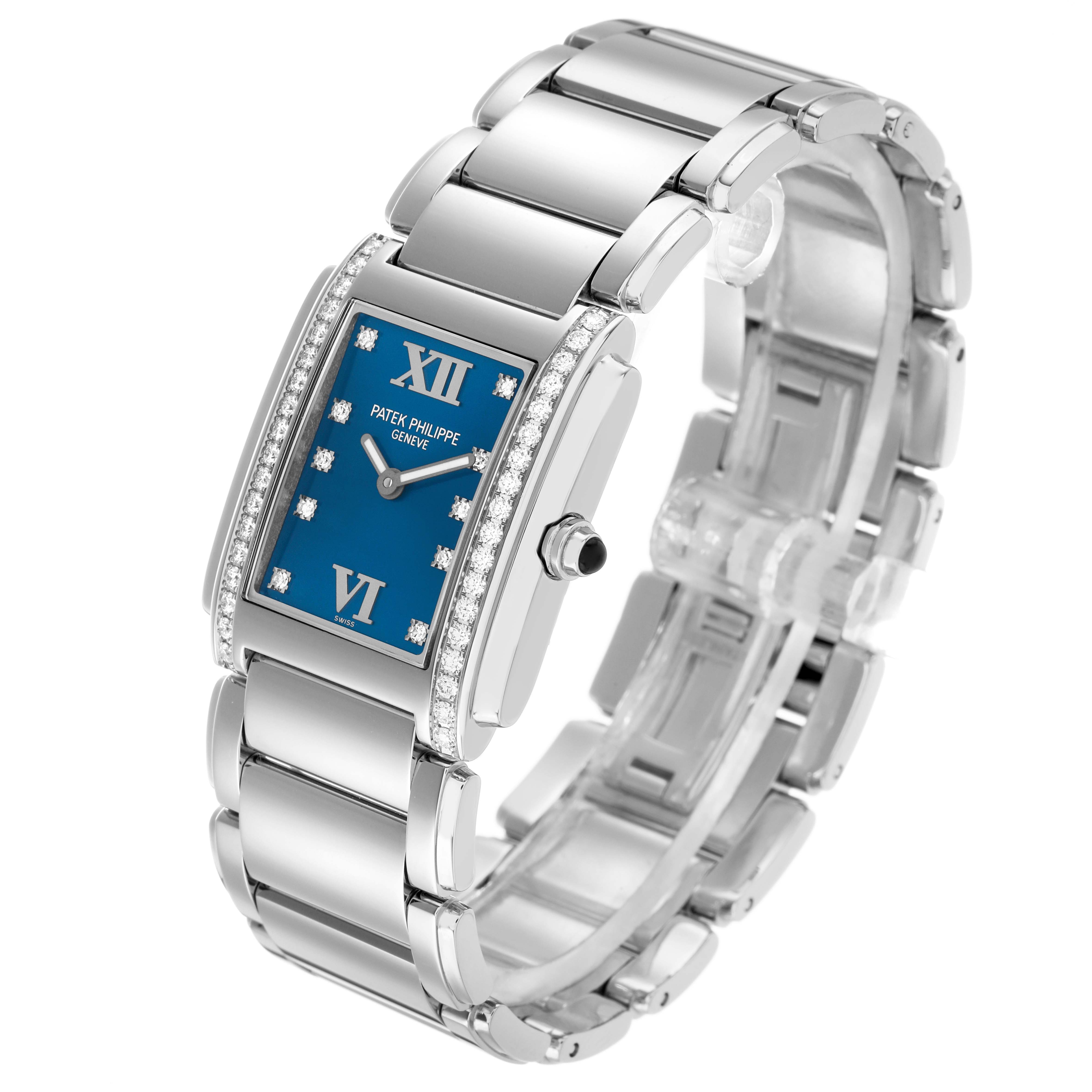 The Patek Philippe Twenty-4 4910/10A Women's Stainless Steel Blue Dial watch is shown from an angled top view, highlighting its blue dial, Roman numerals, and diamond-set bezel.