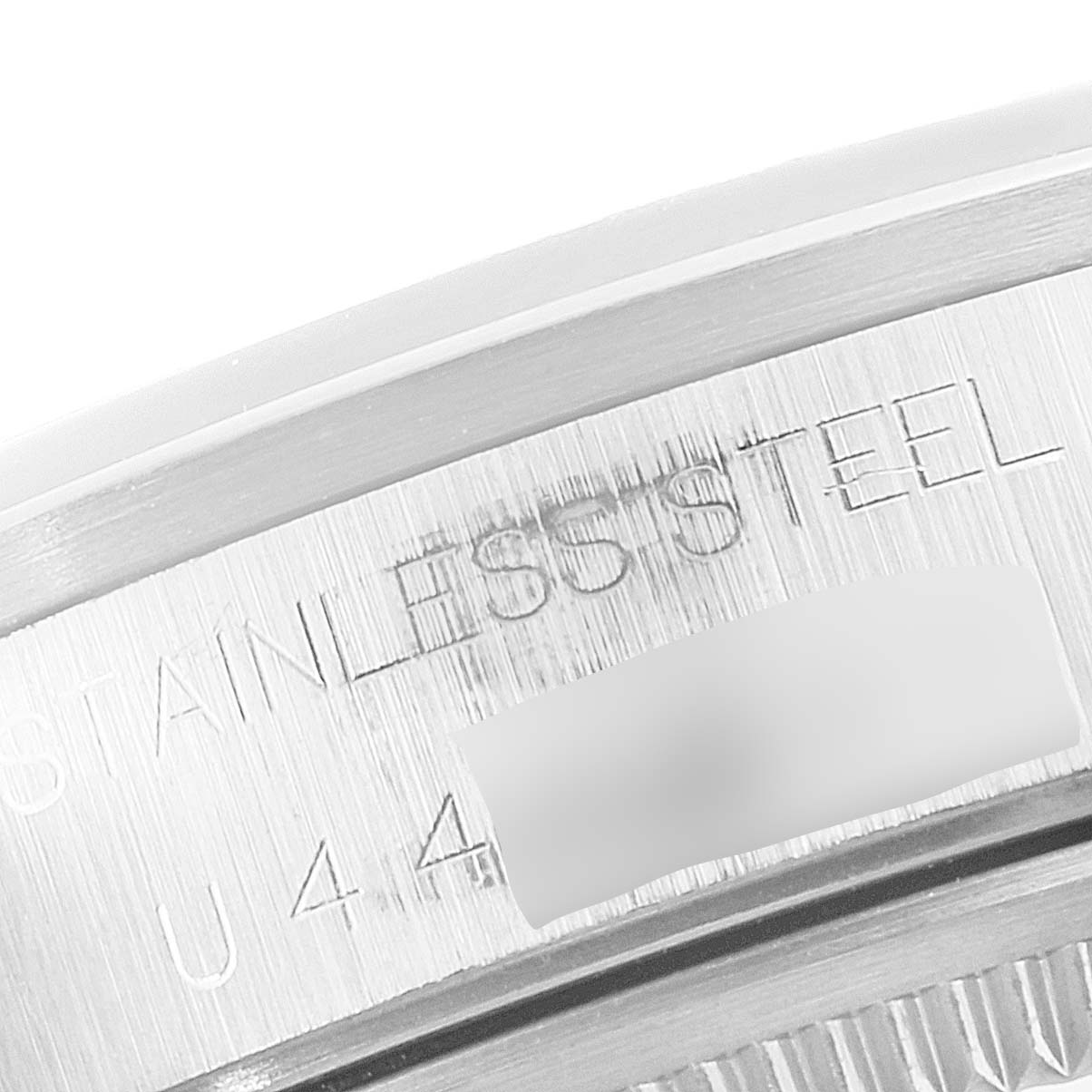 This image shows a close-up of the side casing engraving of a Rolex Air-King 14000 Men's Stainless Steel Blue Dial 14000 Men's Stainless Steel Blue Dial watch, highlighting "Stainless Steel" text.