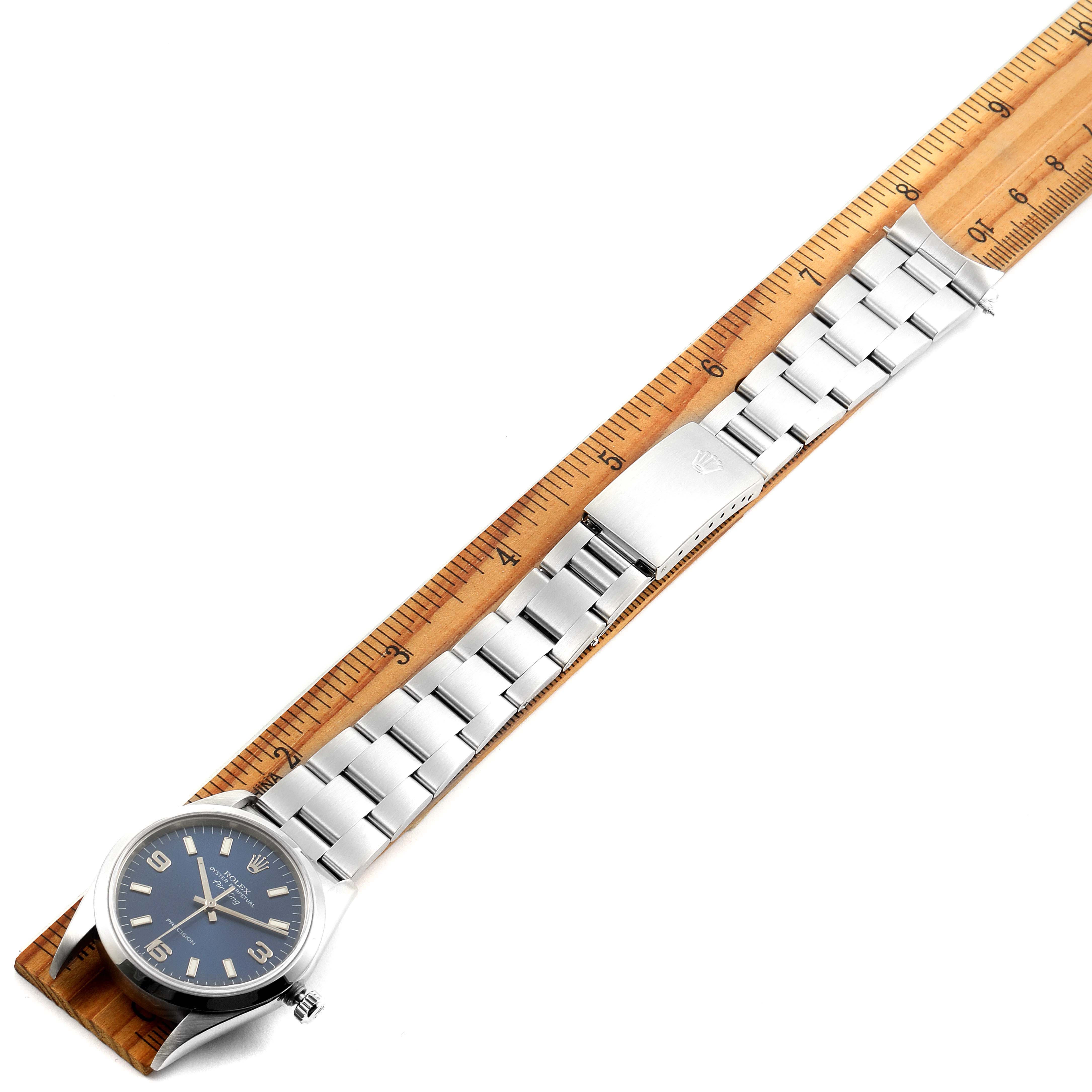 The Rolex Air-King 14000 Men's Stainless Steel Blue Dial 14000 Men's Stainless Steel Blue Dial watch is shown from a top-down angle with its face, bracelet, and clasp visible, placed beside a ruler for size reference.