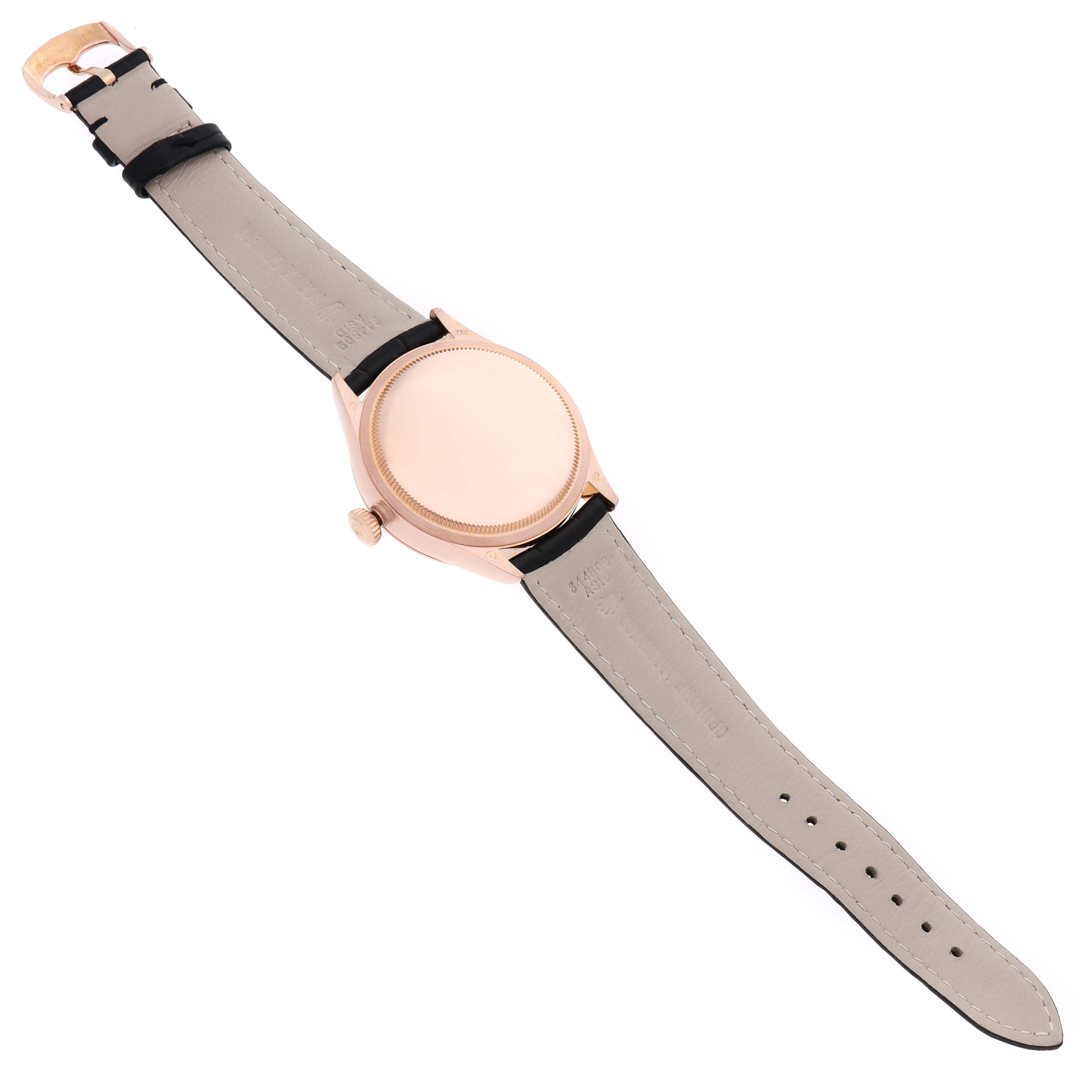 The Rolex Cellini 50515 Men's Rose Gold Black Dial watch is shown from the back, highlighting the case back, strap, and buckle.