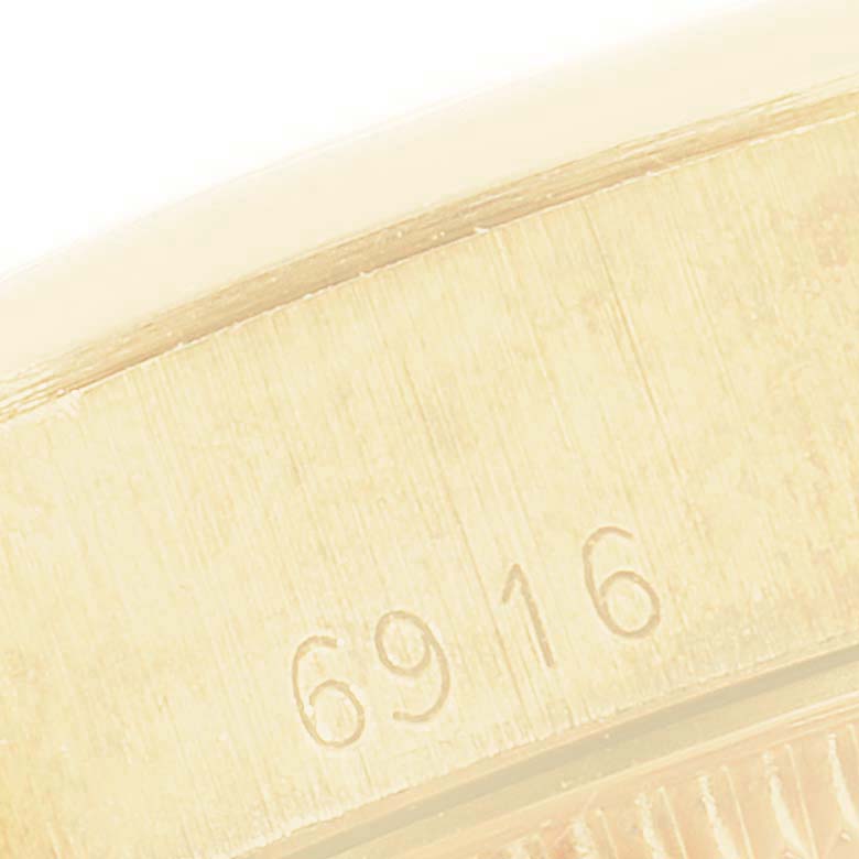 The image shows the engraved model number "6916" on the side of the Rolex President 6916 Women
s Stainless Steel White Dial 6916 Women
s Stainless Steel White Dial watch case.