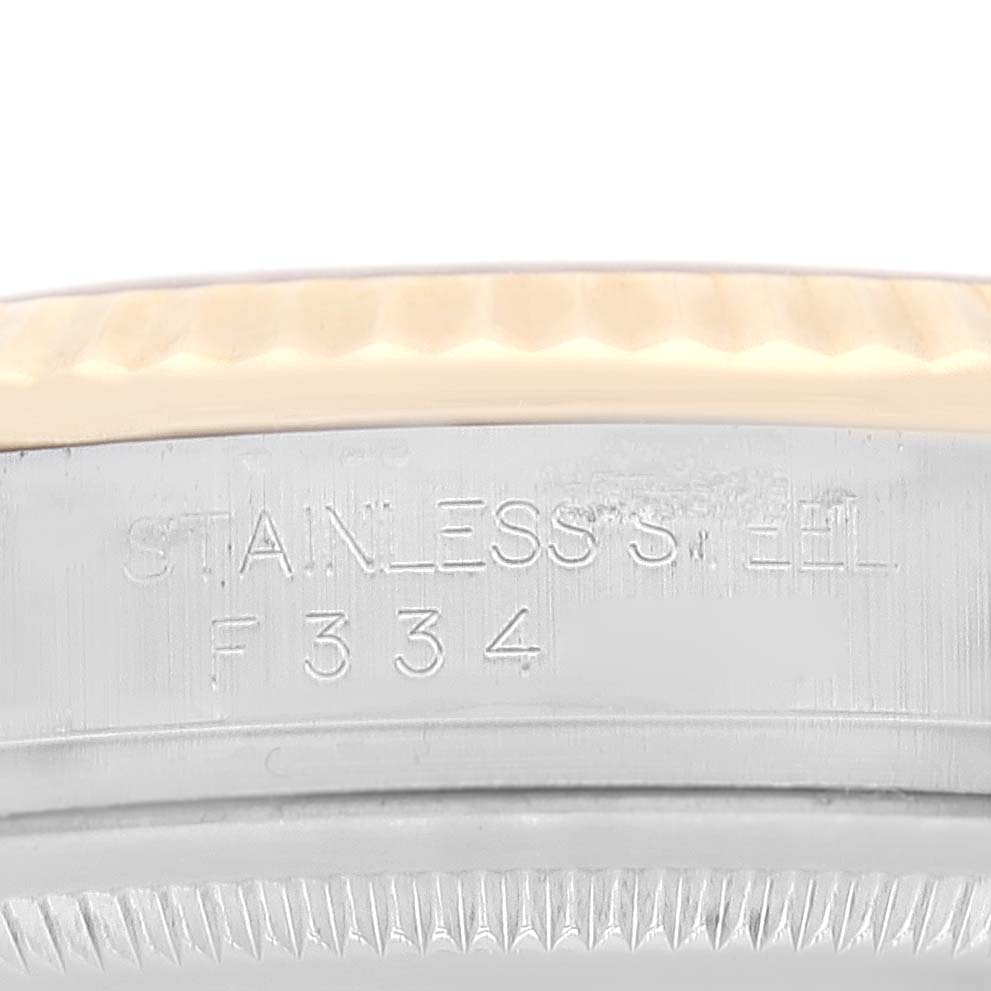 This image shows a close-up of the side of a Rolex Datejust 116233 Men's Steel and Gold (two tone) Champagne Dial 116233 Men's Steel and Gold (two tone) Champagne Dial watch, focusing on the stainless steel engraving and case details.