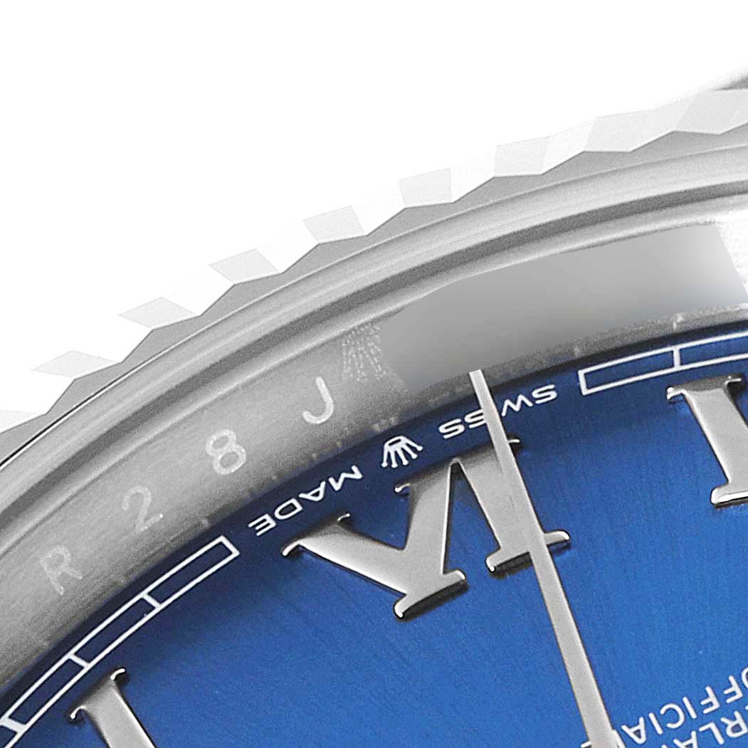 The image shows a close-up angle of the Rolex Datejust 41 126334 Men
s Stainless Steel Blue Dial 126334 Men
s Stainless Steel Blue Dial, focusing on the bezel, part of the dial, and the hands.