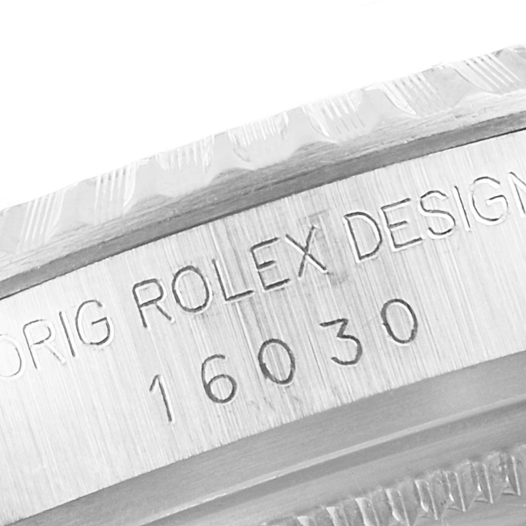 This close-up angle shows the side of the Vintage Collection Rolex watch, highlighting its model number 16030 and the engraved text "ORIG ROLEX DESIGN".