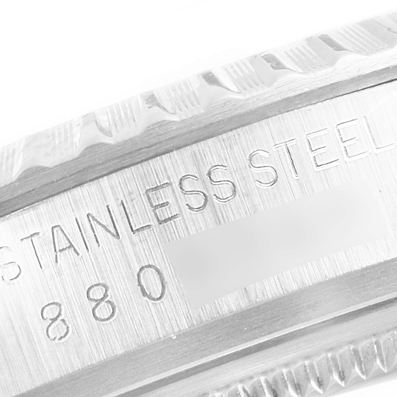 Close-up view of the side of a Vintage Collection Rolex watch, showcasing its stainless steel material and engraved details.