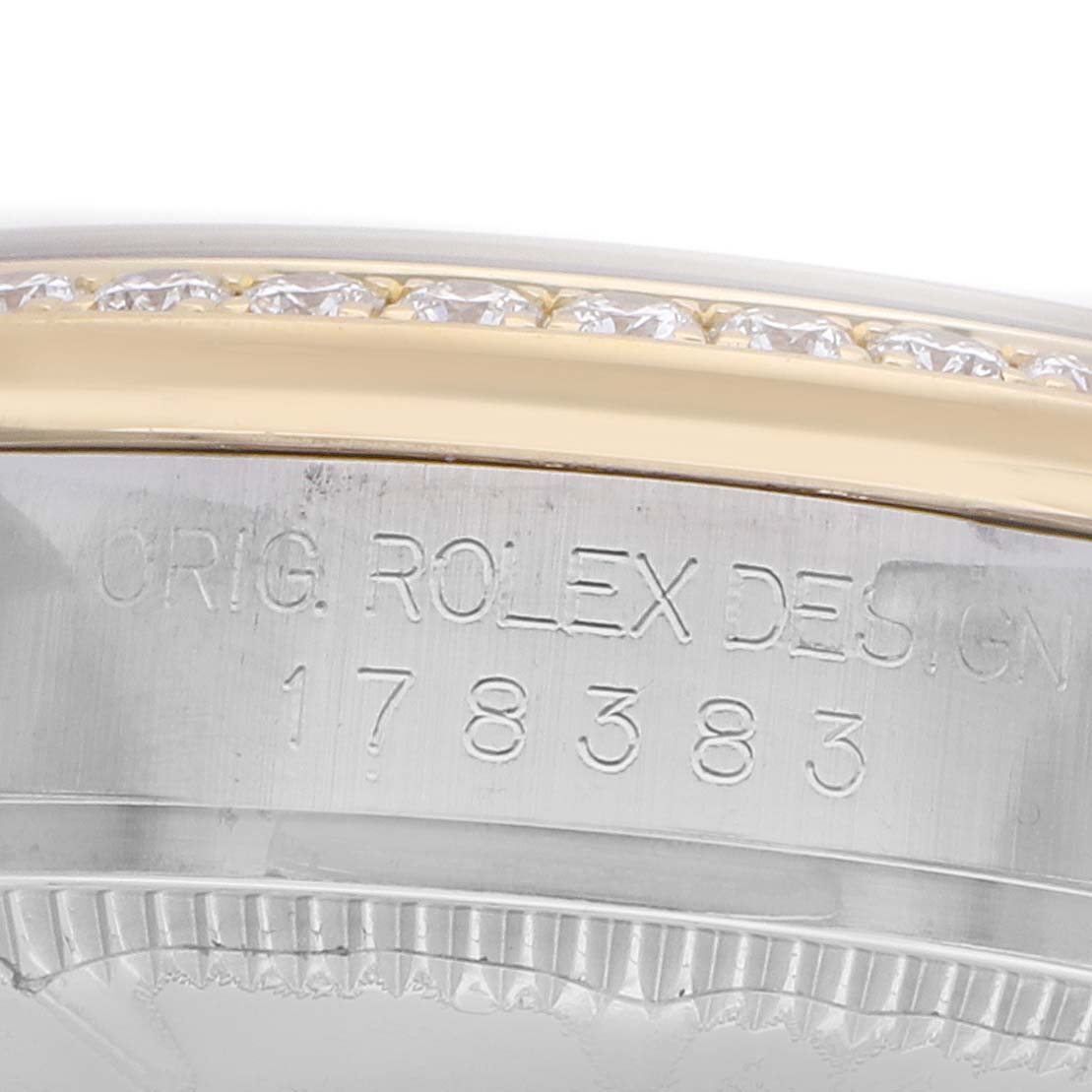 The image shows a close-up of the side of a Rolex Mid-Size 178383 Women's Steel and Gold (two tone) Mother of Pearl Dial watch, highlighting the bezel and engraved model number.