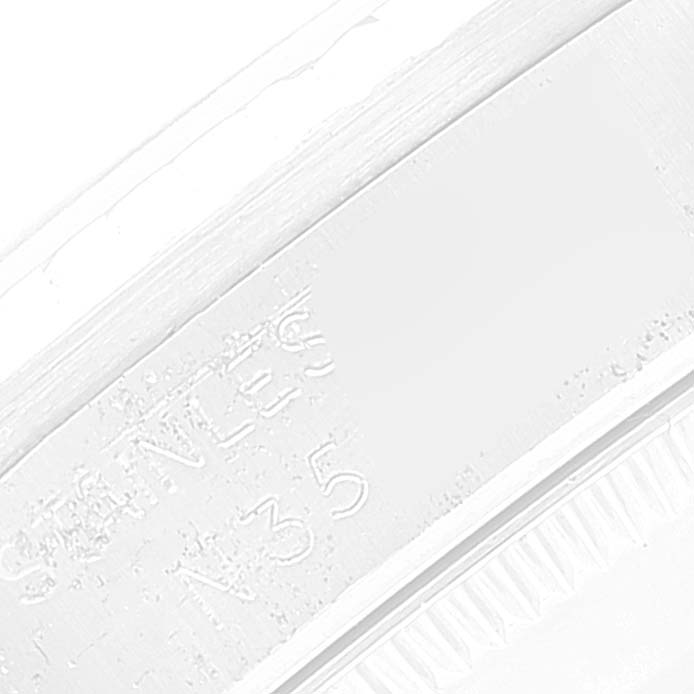 The image shows a close-up angle of the engraving on a Mid-Size Rolex watch
s bezel or back case.