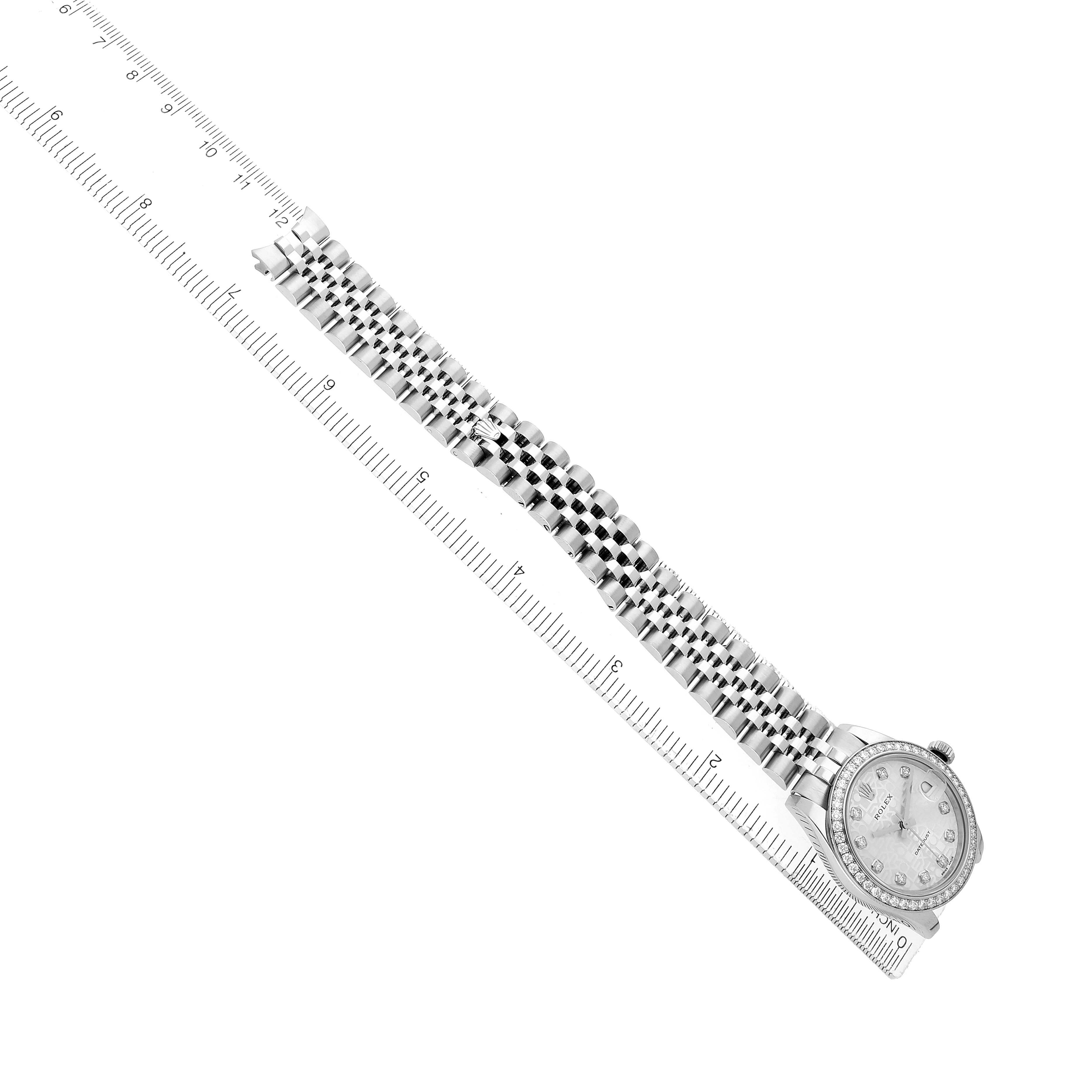 The image shows a Rolex Mid-Size 178384 Women's Stainless Steel Silver Dial watch laid flat with its bracelet extended along a ruler, viewed from the top.