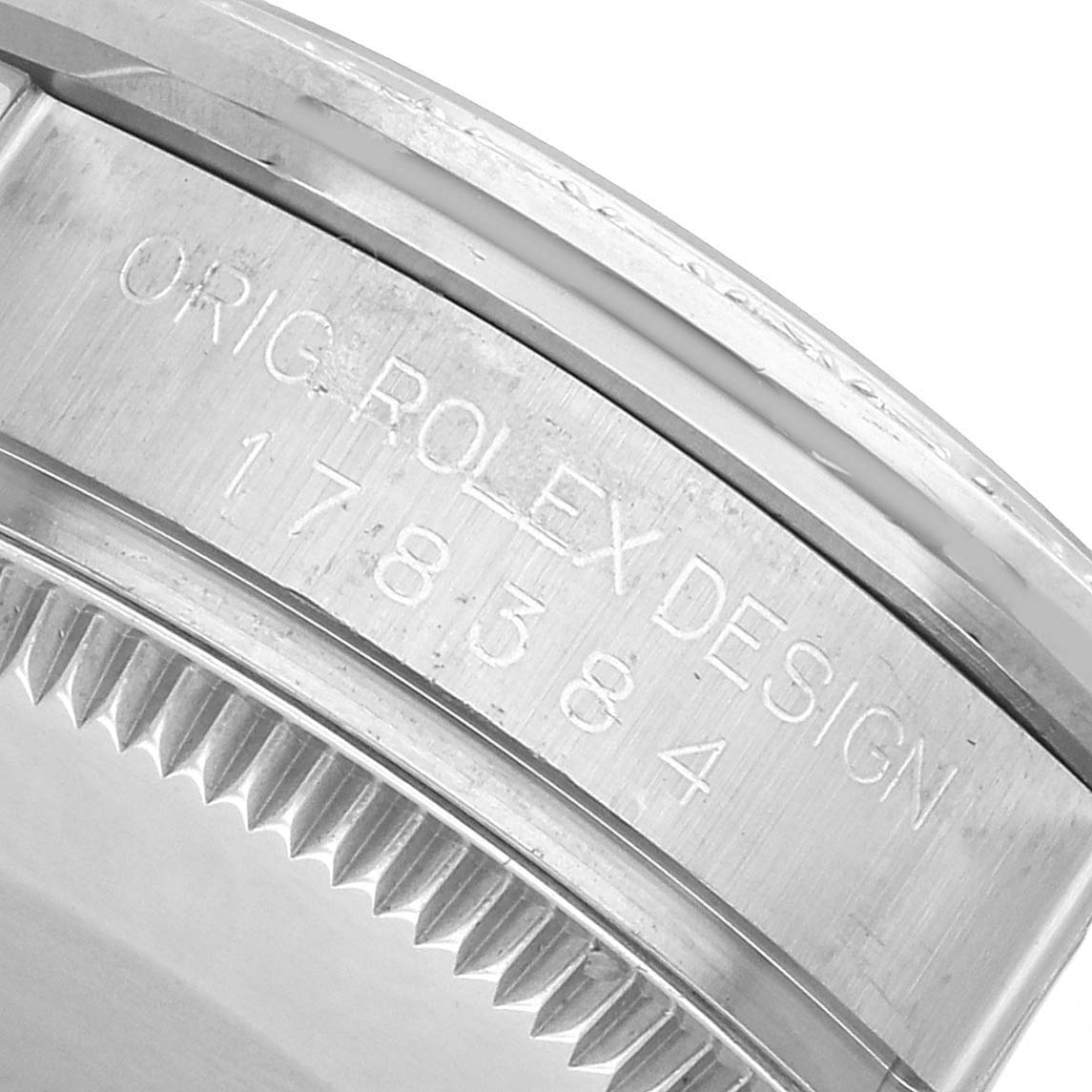 The image shows the bezel and case side with engraved text on a Mid-Size Rolex watch.