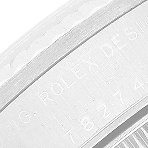 This image shows a close-up of the serial number engraving on the case of a Mid-Size Rolex watch.