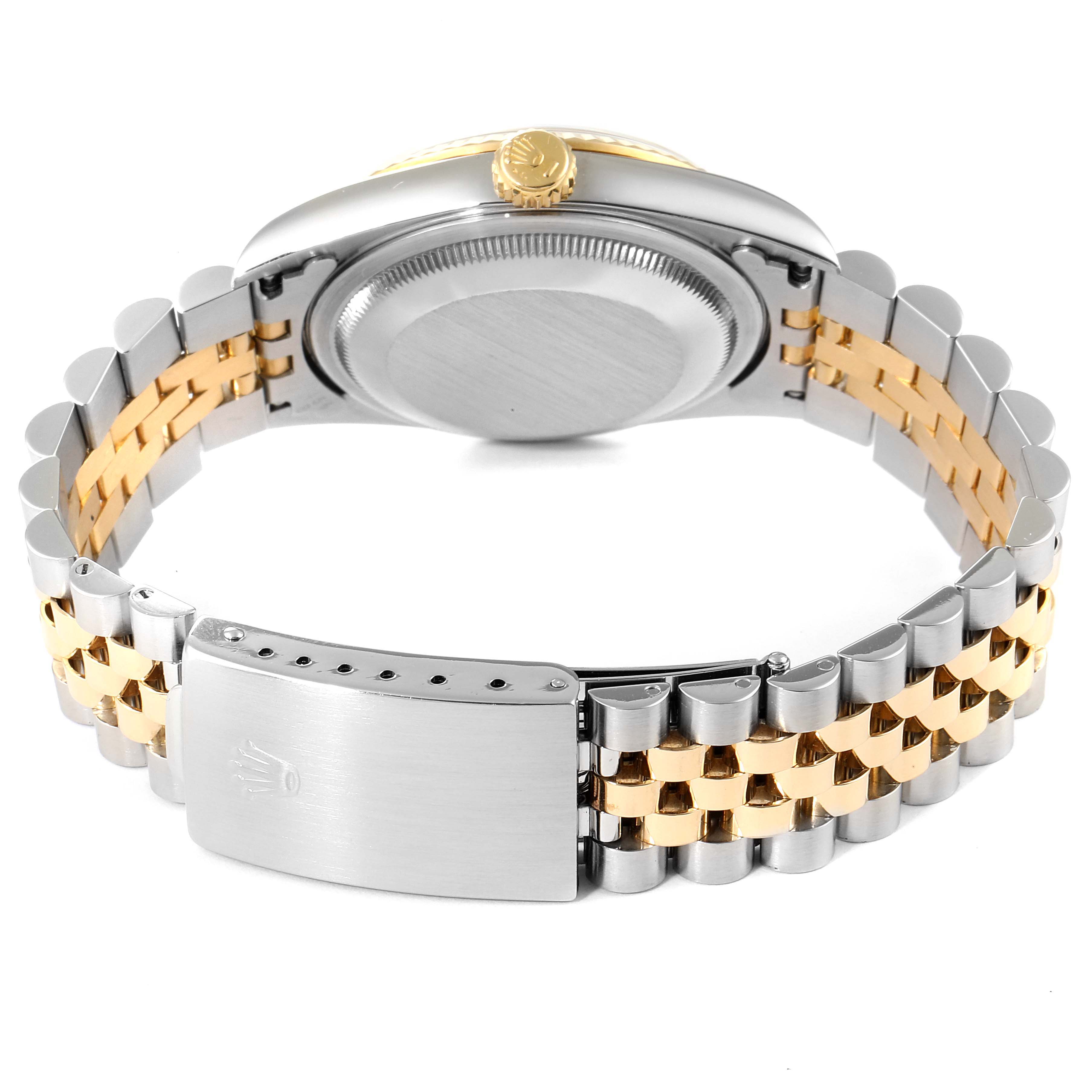 The image shows the back and side of a Rolex Datejust 16233 Men's Steel and Gold (two tone) Champagne Dial 16233 Men's Steel and Gold (two tone) Champagne Dial watch, featuring its gold and silver two-tone bracelet and clasp.