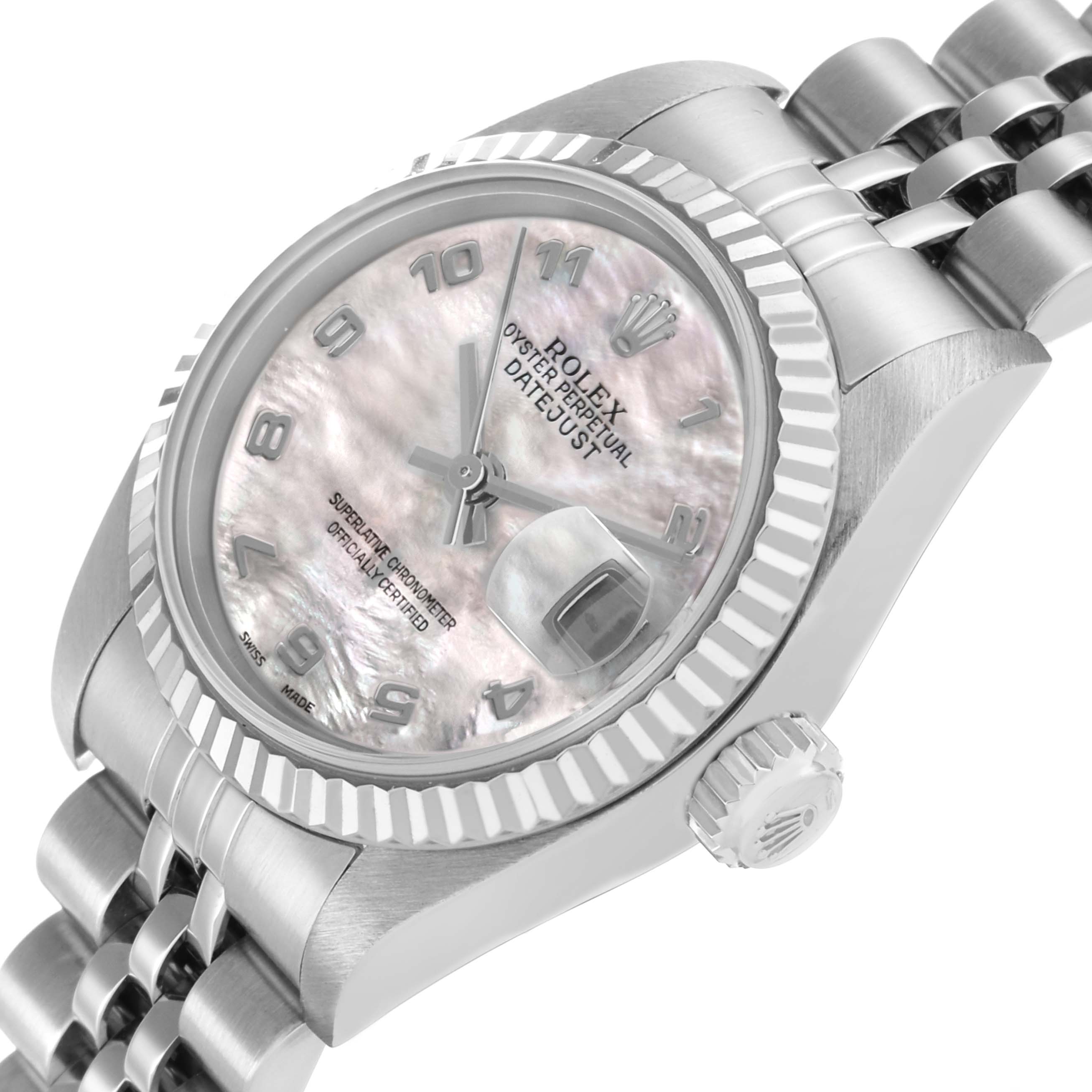 The Rolex Datejust 79174 Women's Stainless Steel Mother of Pearl Dial watch is shown at an angled view highlighting the dial, bezel, crown, and part of the bracelet.